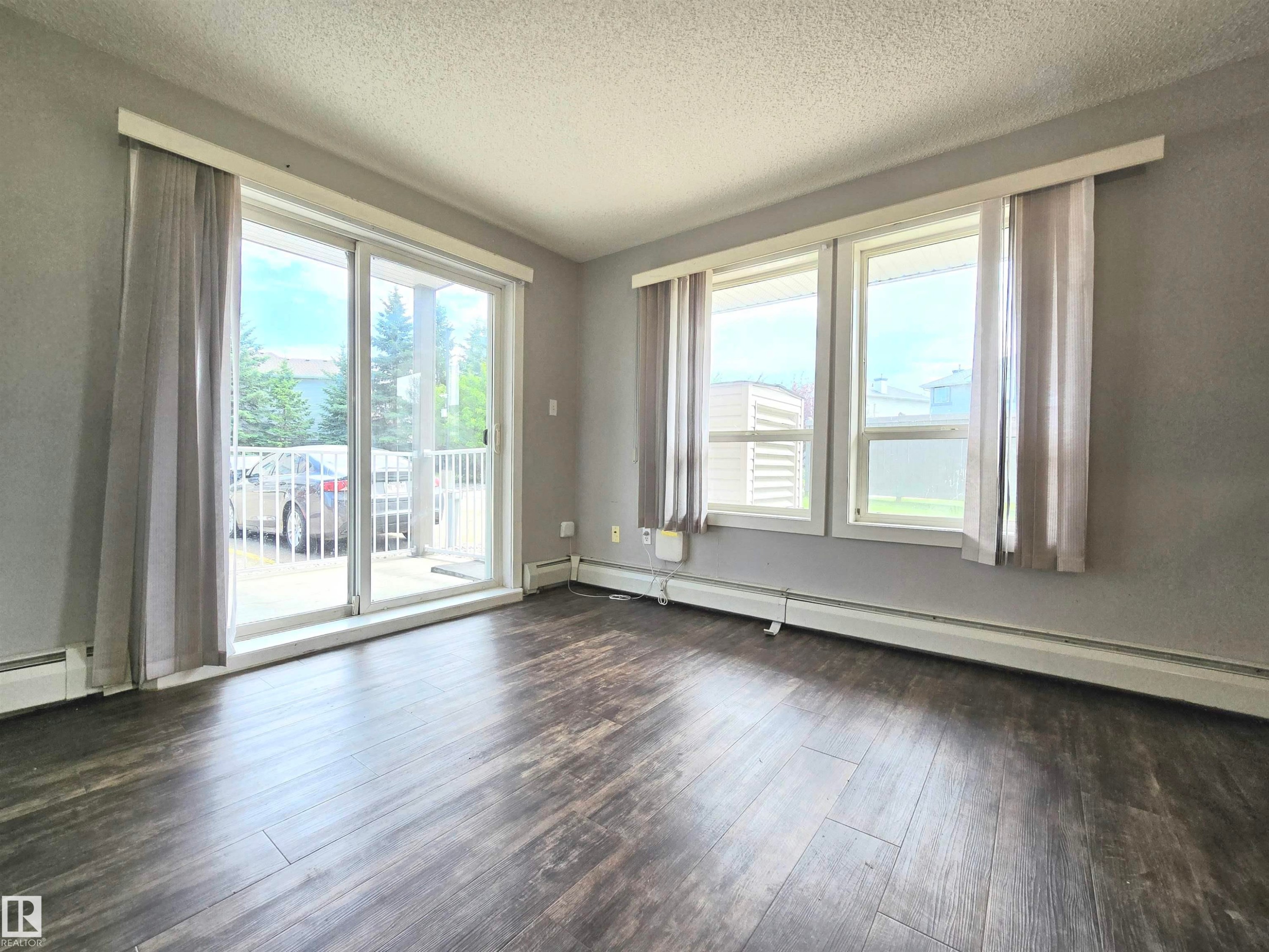 Spacious room with plenty of natural light and additional windows, as it is a corner unit. - #105 155 Edwards Dr Sw, Edmonton, AB - Indoor Photo Showing Other Room