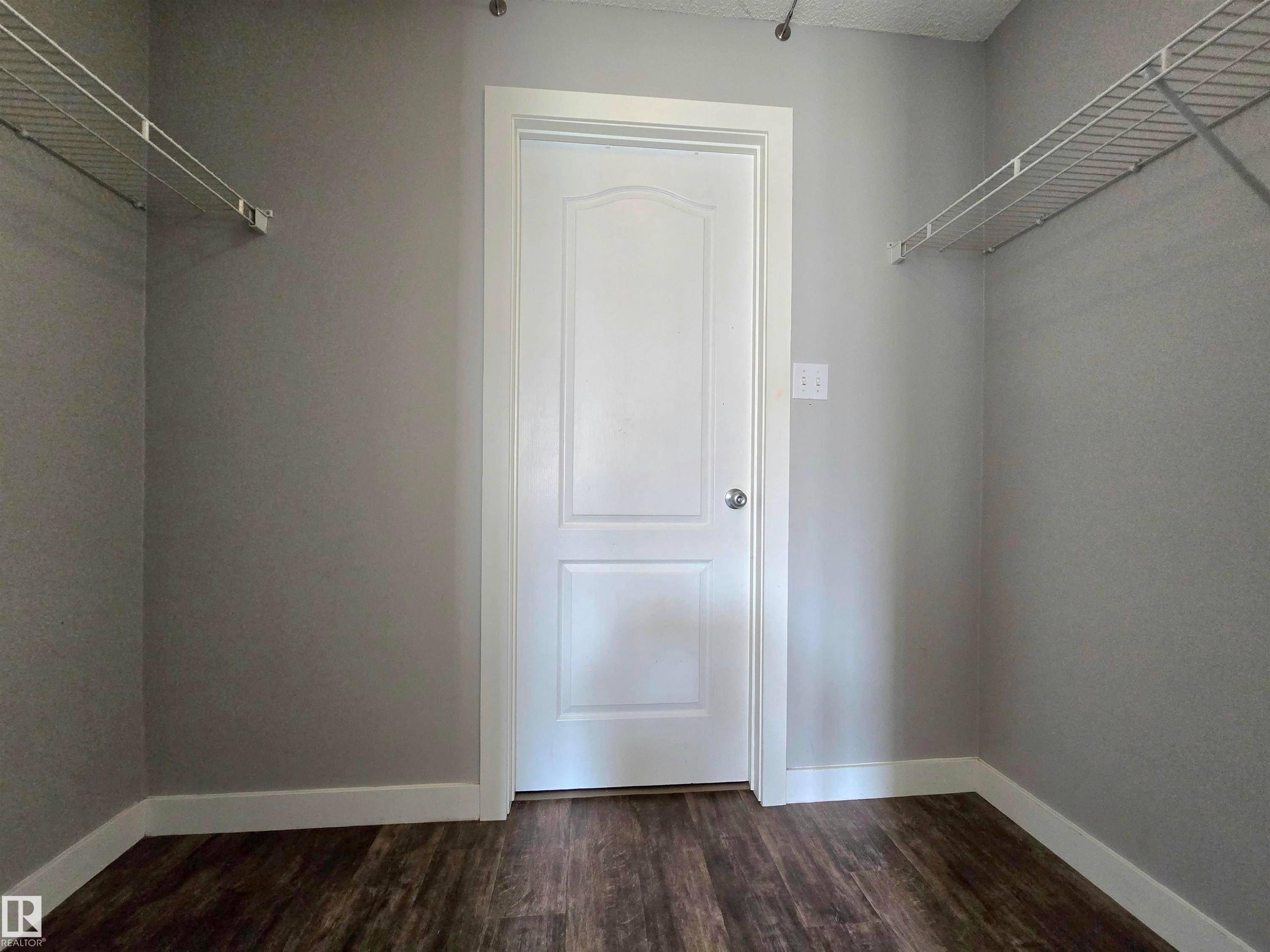 The primary bedroom features a walk-through closet that leads into the master ensuite - #105 155 Edwards Dr Sw, Edmonton, AB - Indoor With Storage
