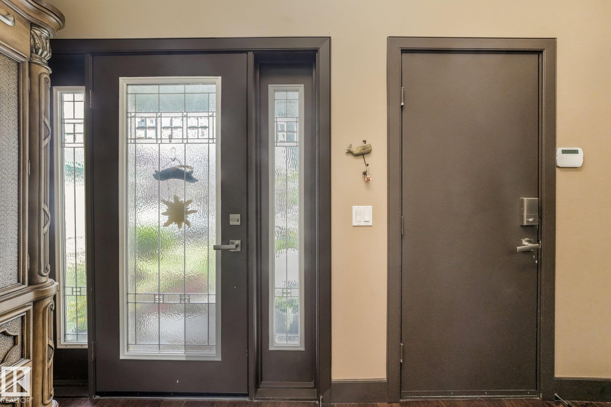 Entry door with decorative glass panels and sidelights - 12827 150 Avenue Nw, Edmonton, AB