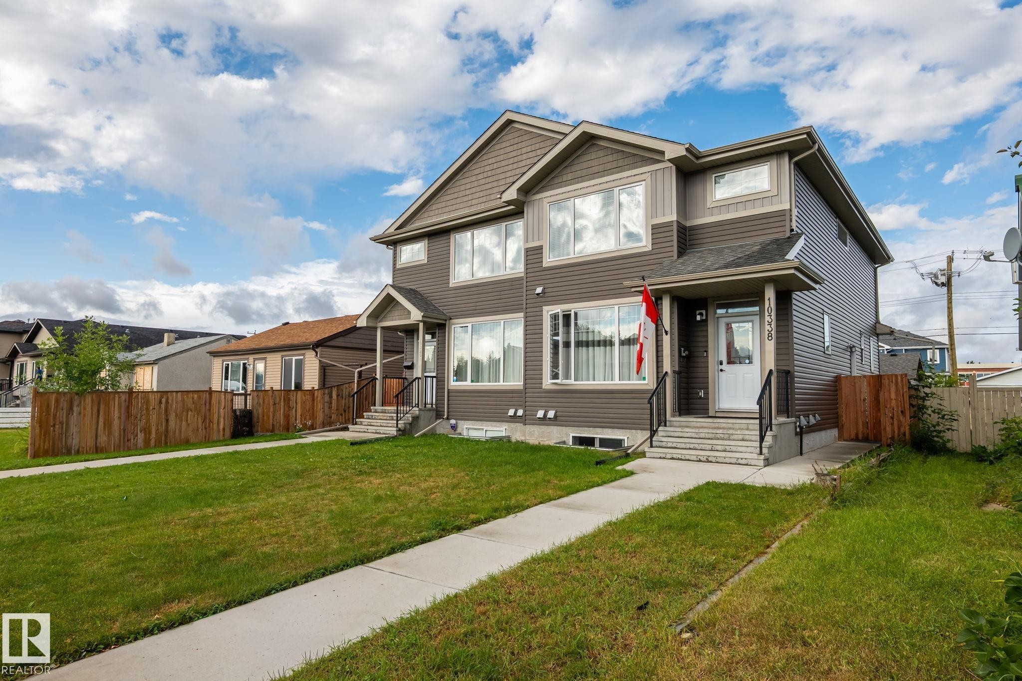 Multi-level exterior with dark siding, light trim, and prominent windows - 10338 162St Nw, Edmonton, AB