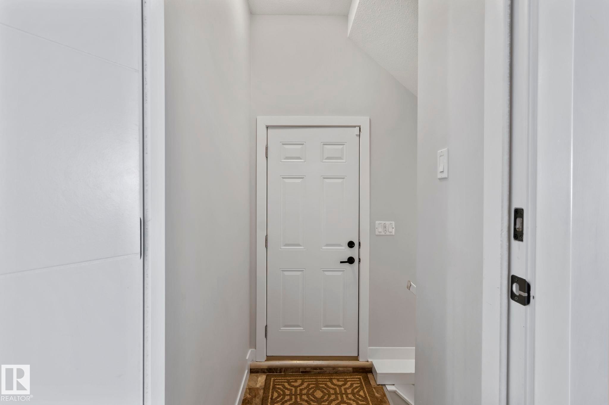 White paneled door with black hardware - 10338 162St Nw, Edmonton, AB