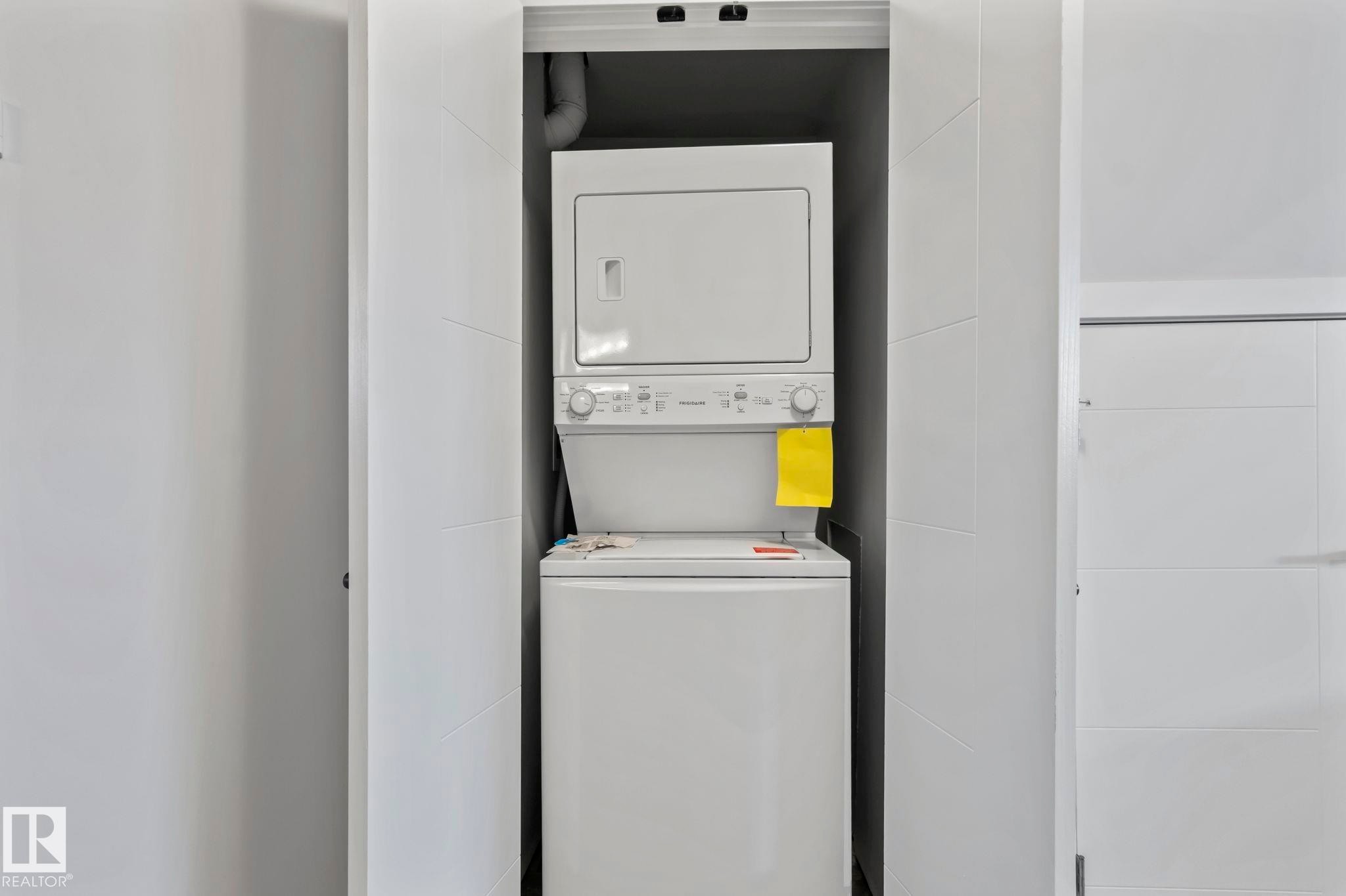 Stackable laundry appliances are housed in a dedicated alcove - 10338 162St Nw, Edmonton, AB