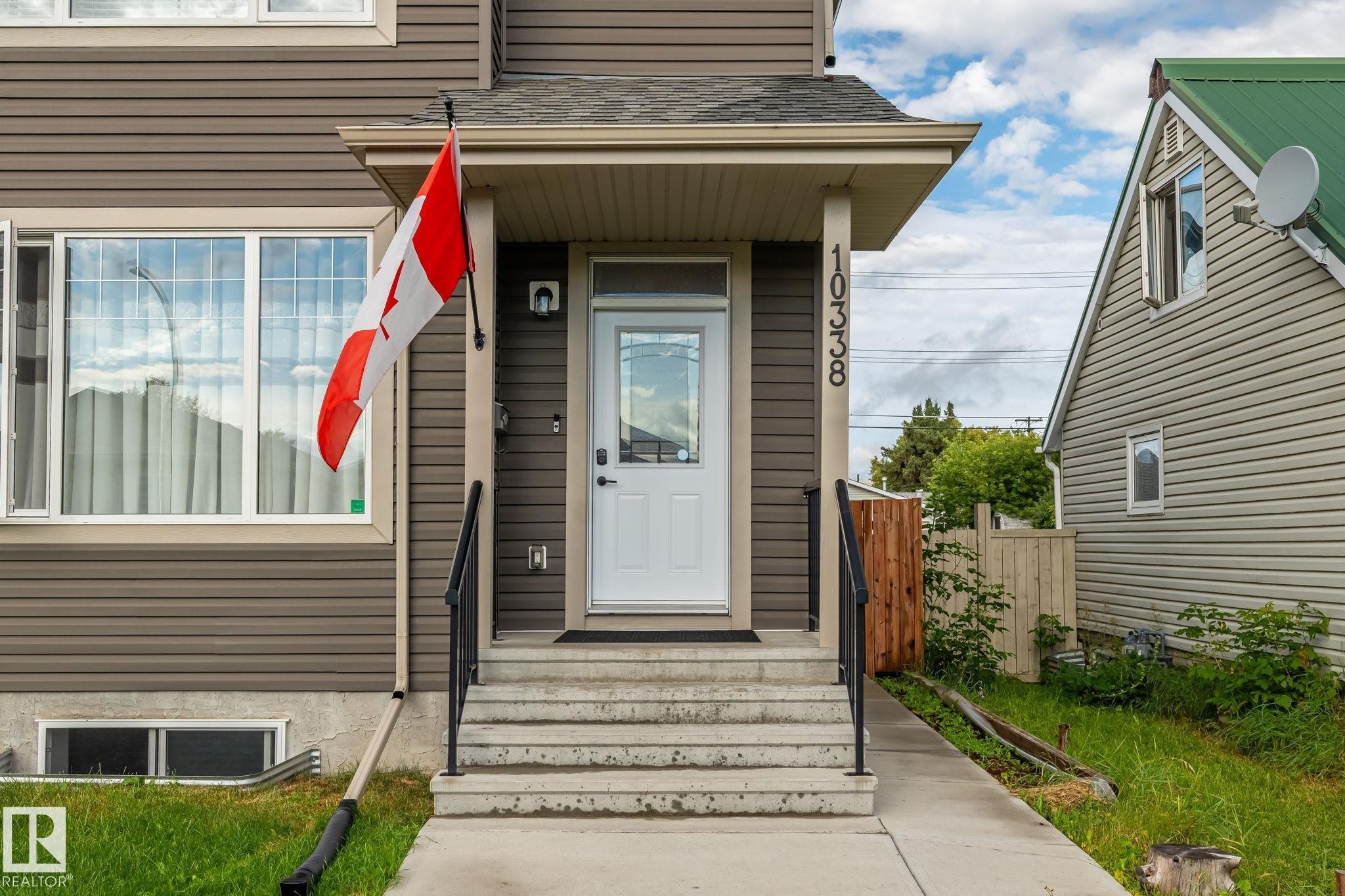 Siding exterior with white trim windows and a covered front entry - 10338 162St Nw, Edmonton, AB
