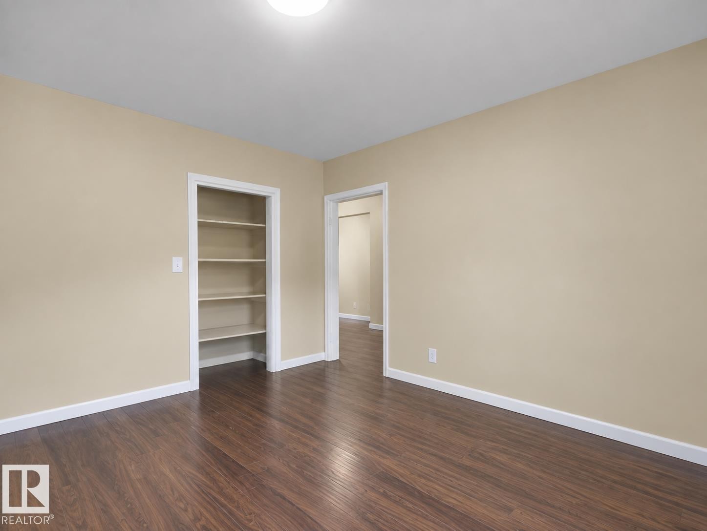 Wood-finish flooring, built-in shelving, neutral wall tones, and overhead lighting - 12002 48 Street Nw, Edmonton, AB