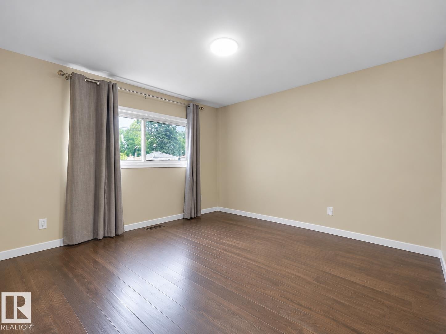 Recessed ceiling light, wood-finish flooring, neutral wall tones, and window with natural light - 12002 48 Street Nw, Edmonton, AB