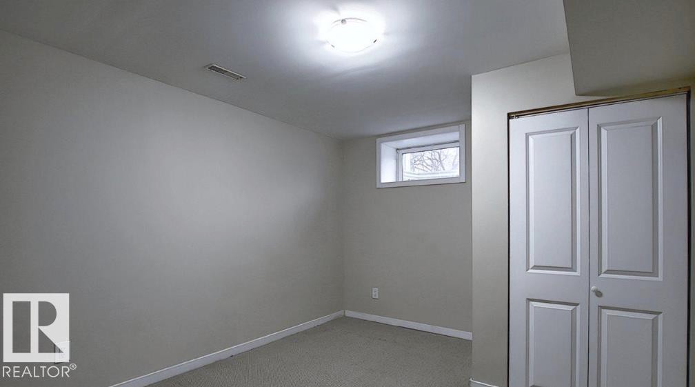 Recessed window, ceiling-mounted light fixture, and bi-fold closet doors with paneling - 12002 48 Street Nw, Edmonton, AB
