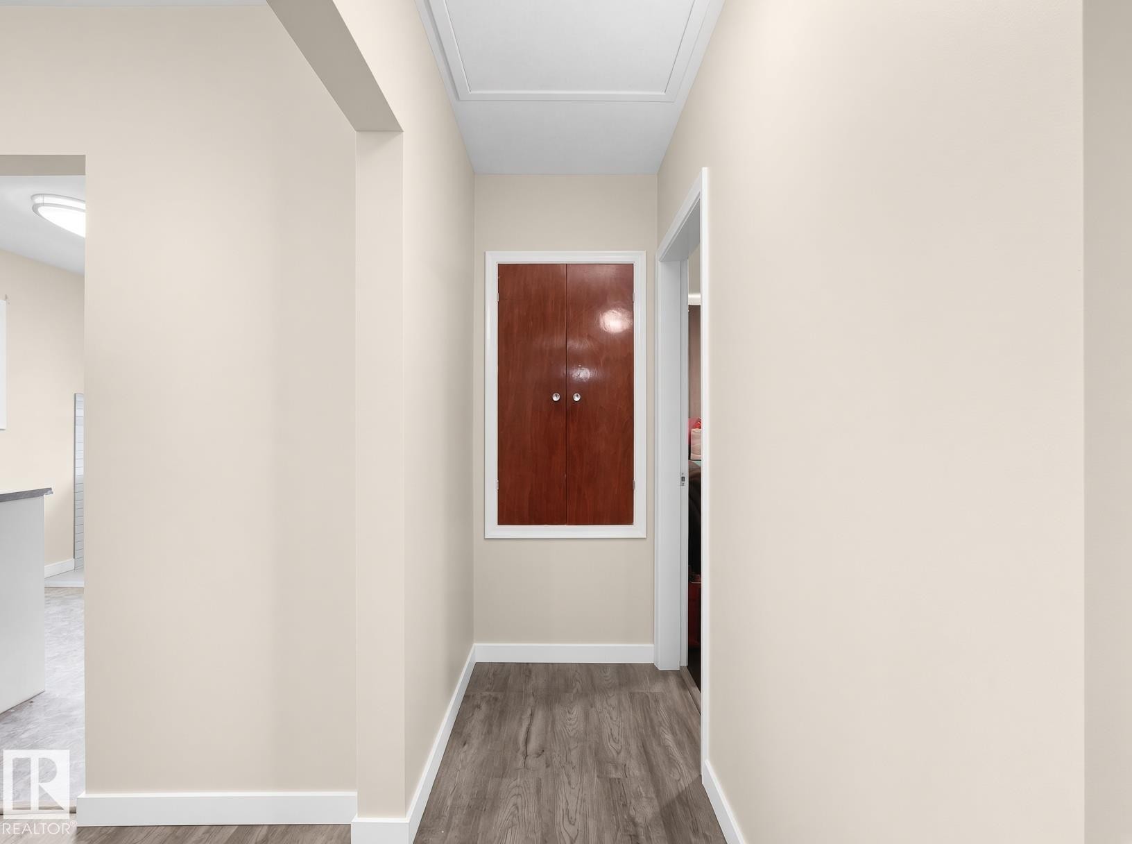 Wood-finish flooring with white trim and a recessed ceiling panel - 12002 48 Street Nw, Edmonton, AB