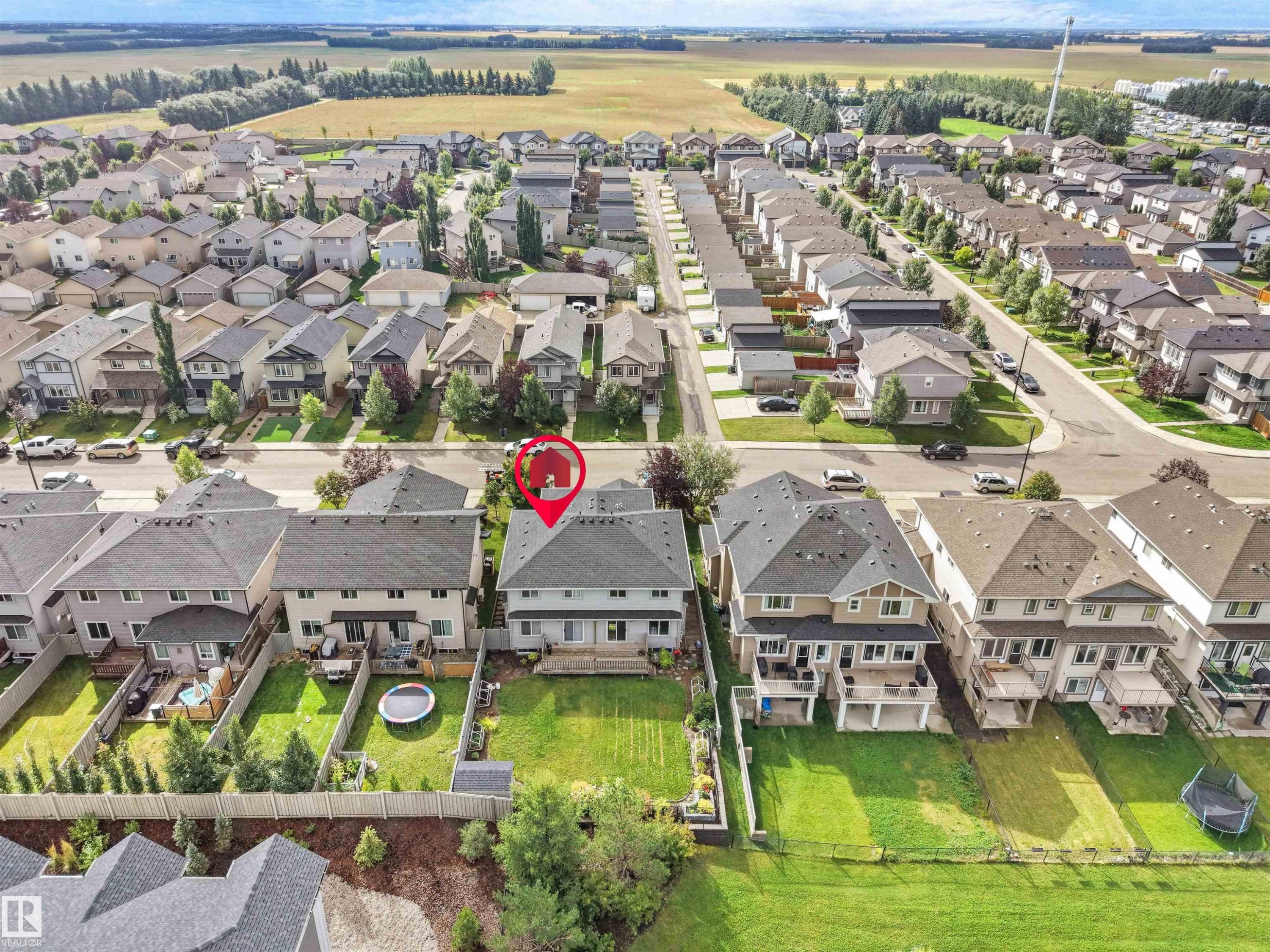 Expansive green space and a manicured lawn extend from the property - 6656 Cardinal Rd Sw, Edmonton, AB