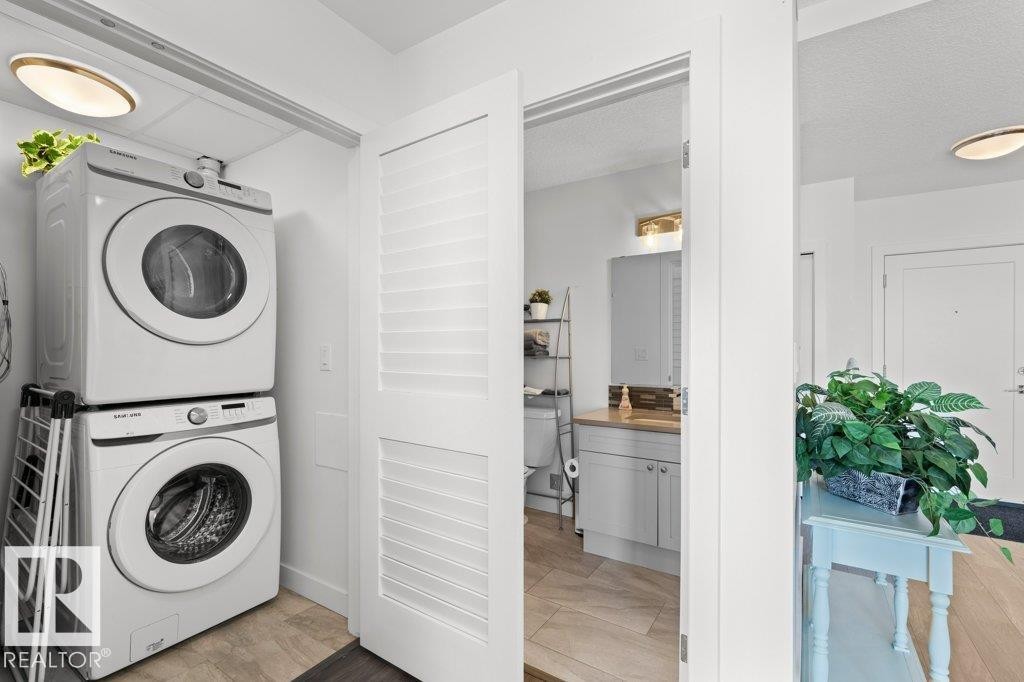 Dedicated laundry area featuring stacked front-load washer and dryer units - 1316 Windermere Way Sw, Edmonton, AB