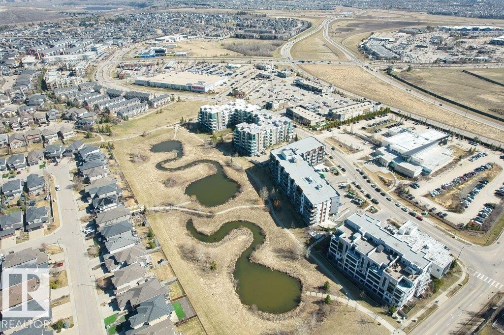 Aerial perspective of a multi-building development with contemporary architecture, featuring multiple stories and balconies - 1316 Windermere Way Sw, Edmonton, AB