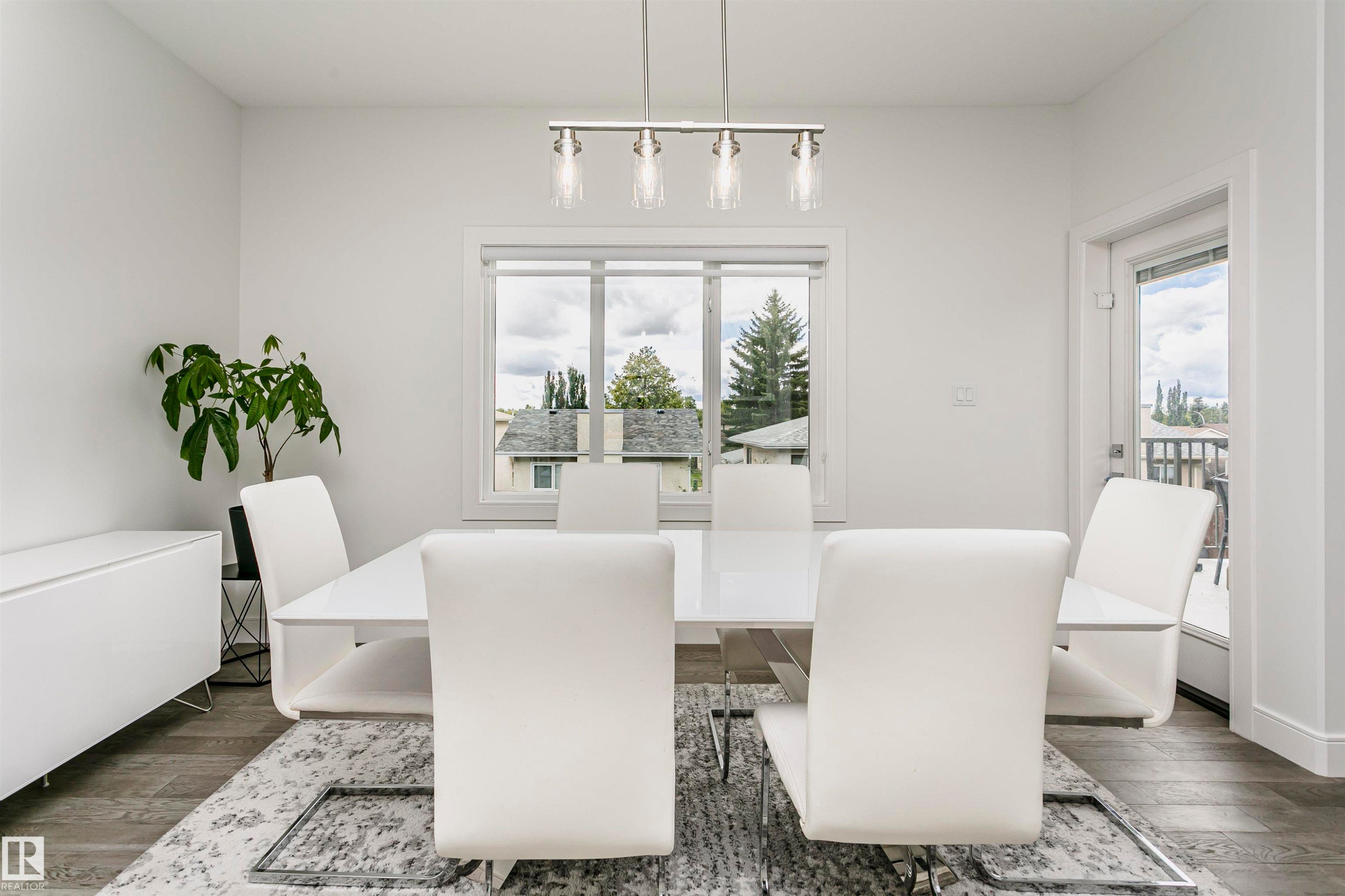 Recessed window with white trim, wood-finish flooring, white walls, and track lighting with clear glass shades - 9107 181 Avenue Nw, Edmonton, AB