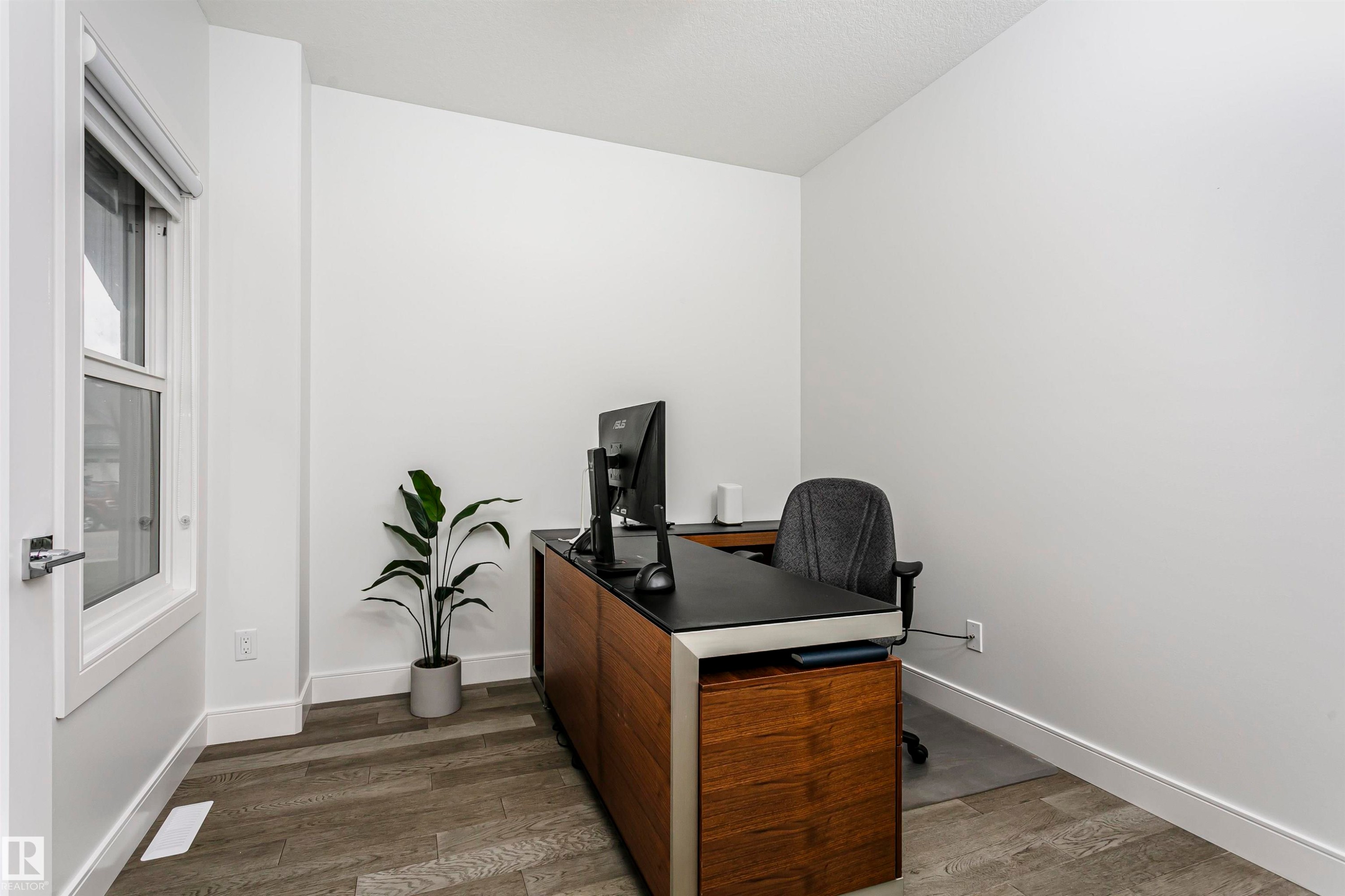 Wood-finish flooring with crisp white walls and white trim - 9107 181 Avenue Nw, Edmonton, AB