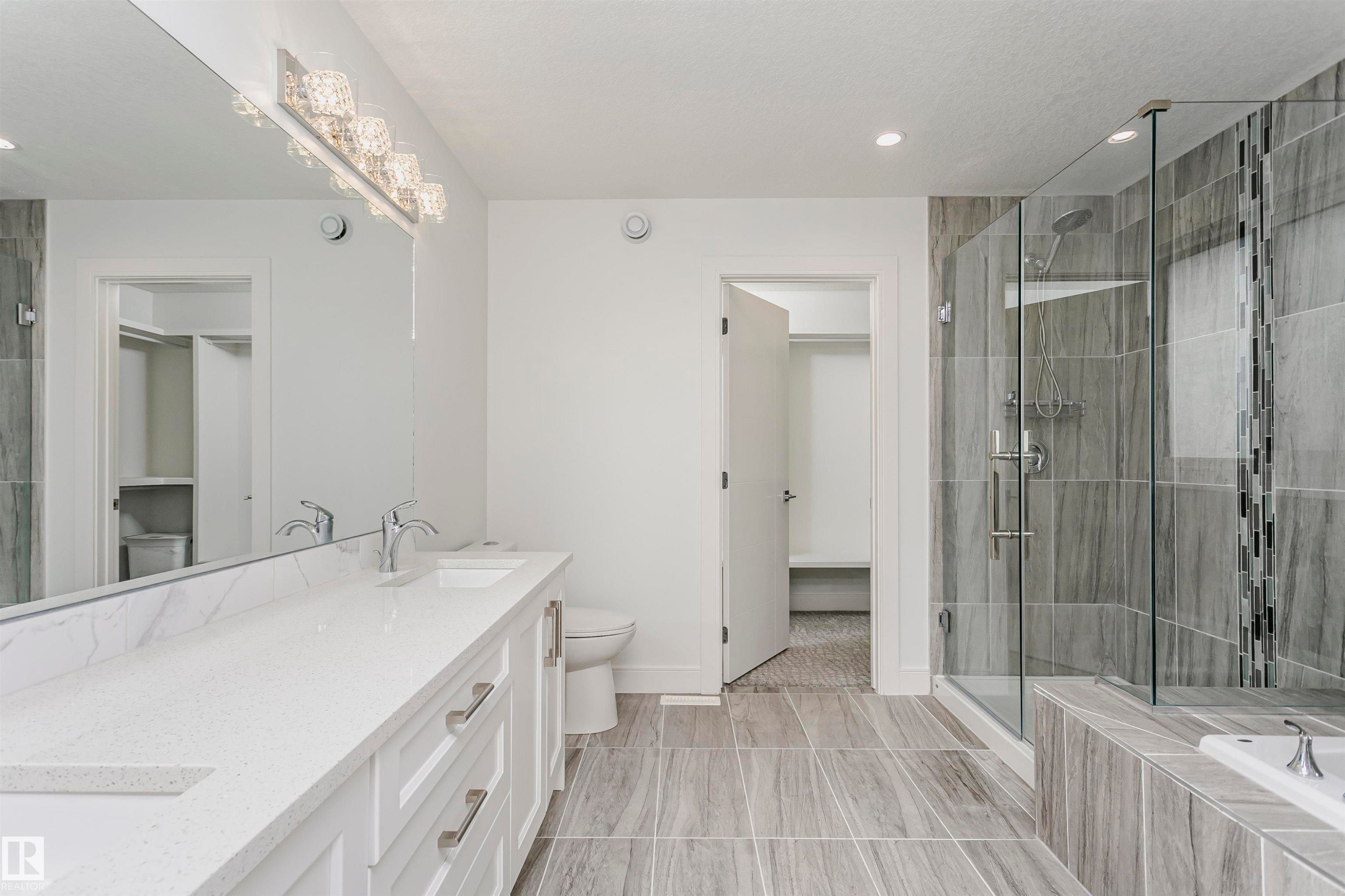 Dual vanity with white cabinetry and a light-colored countertop - 9107 181 Avenue Nw, Edmonton, AB