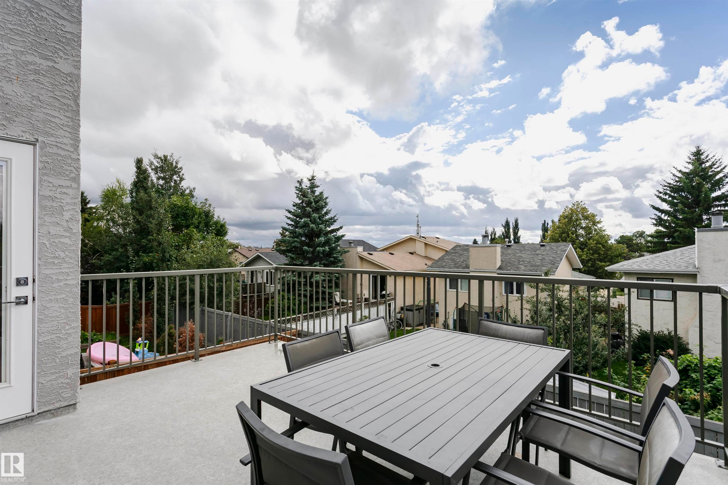 Generous balcony with textured stucco exterior and metal railing - 9107 181 Avenue Nw, Edmonton, AB