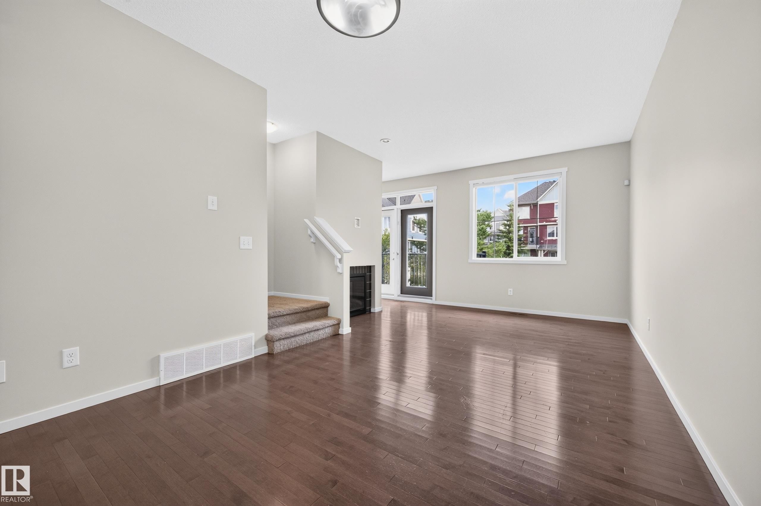 Hardwood flooring, painted walls, white trim, recessed lighting, and a glass-paneled door - #72 603 Watt Bv Sw Sw, Edmonton, AB