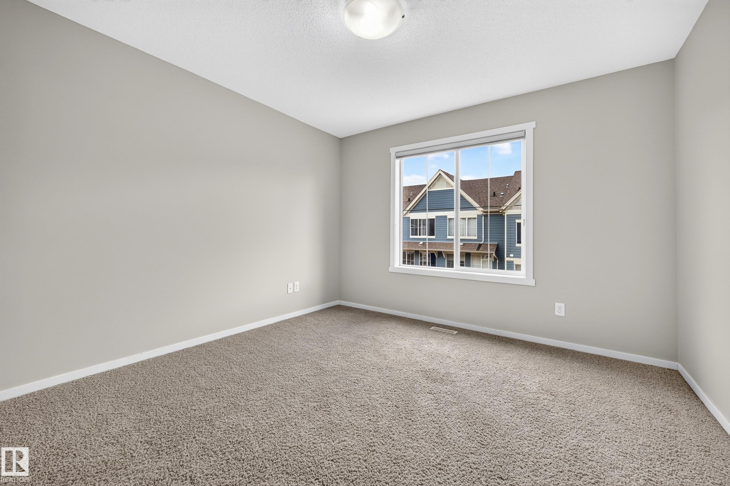 Neutral wall tones, plush carpet, and a white-framed window - #72 603 Watt Bv Sw Sw, Edmonton, AB