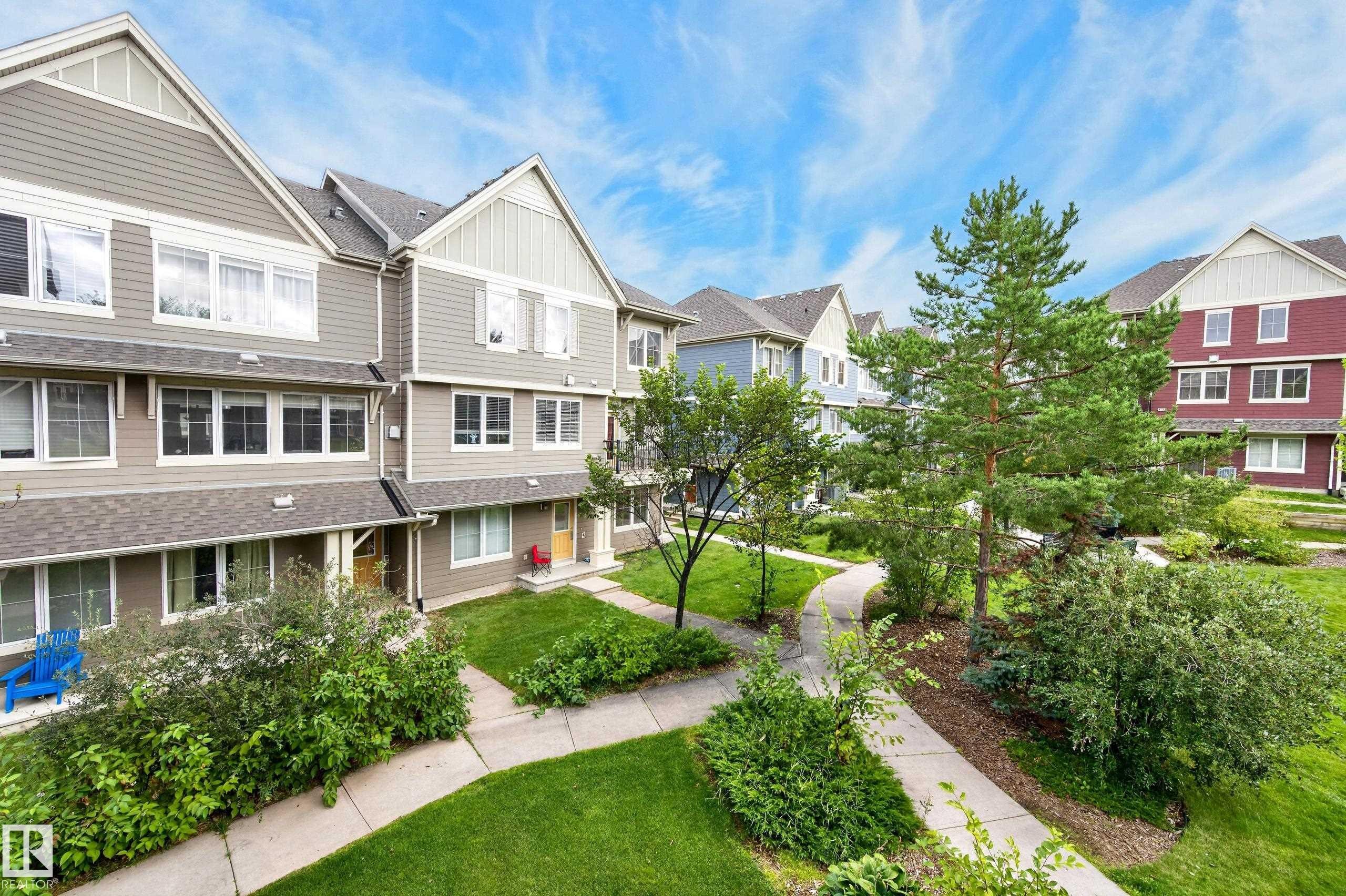 Multi-story residential buildings featuring gabled roofs and varied siding textures - #72 603 Watt Bv Sw Sw, Edmonton, AB