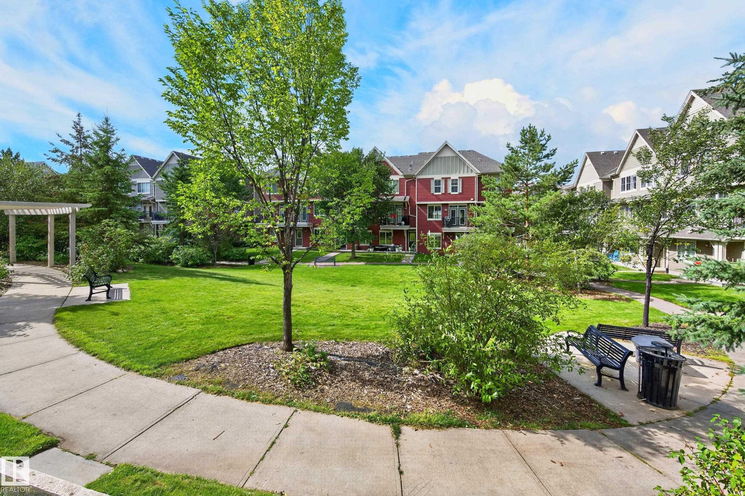 Landscaped common area featuring mature trees and green spaces - #72 603 Watt Bv Sw Sw, Edmonton, AB
