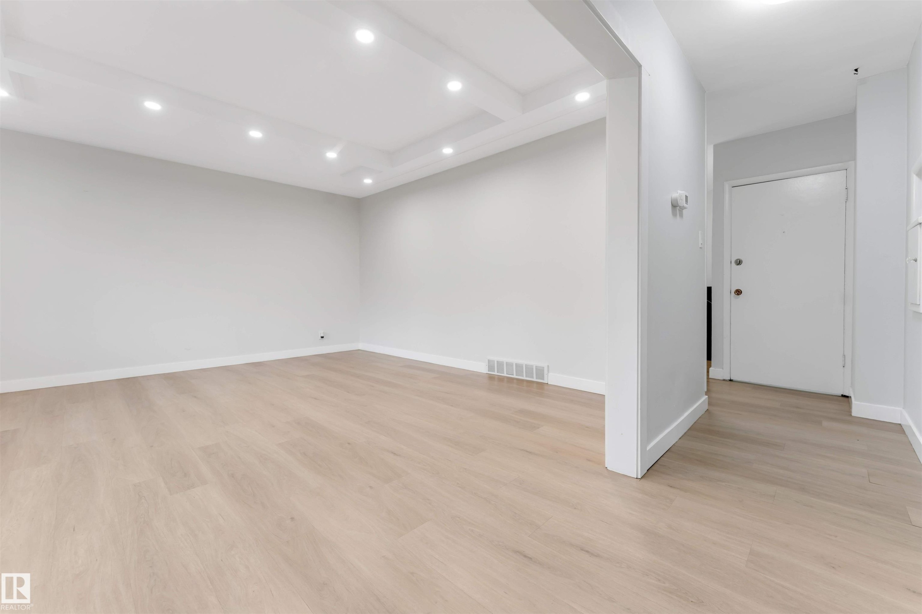 Recessed lighting illuminates the coffered ceiling and light wood-finish flooring - 7928 82 Avenue Nw, Edmonton, AB