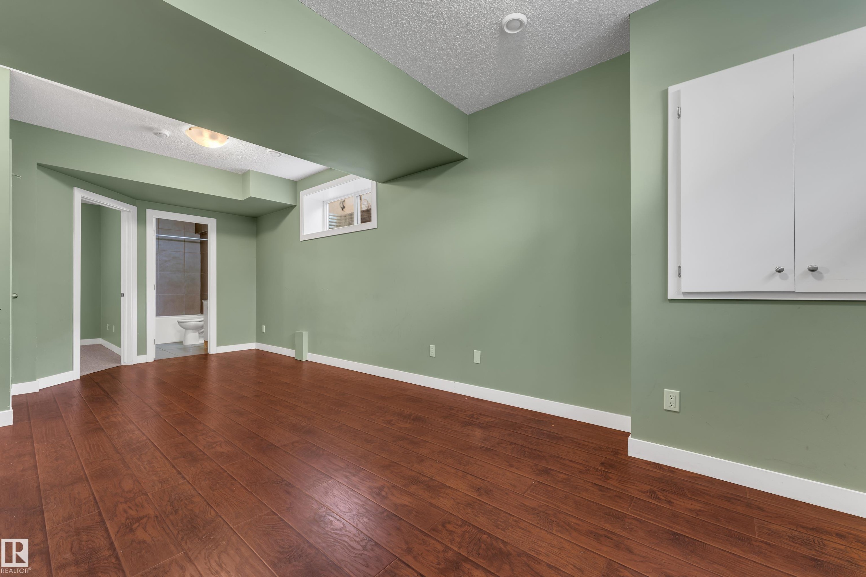 Wood-finish flooring with light green painted walls - 11421 82 Street Nw, Edmonton, AB