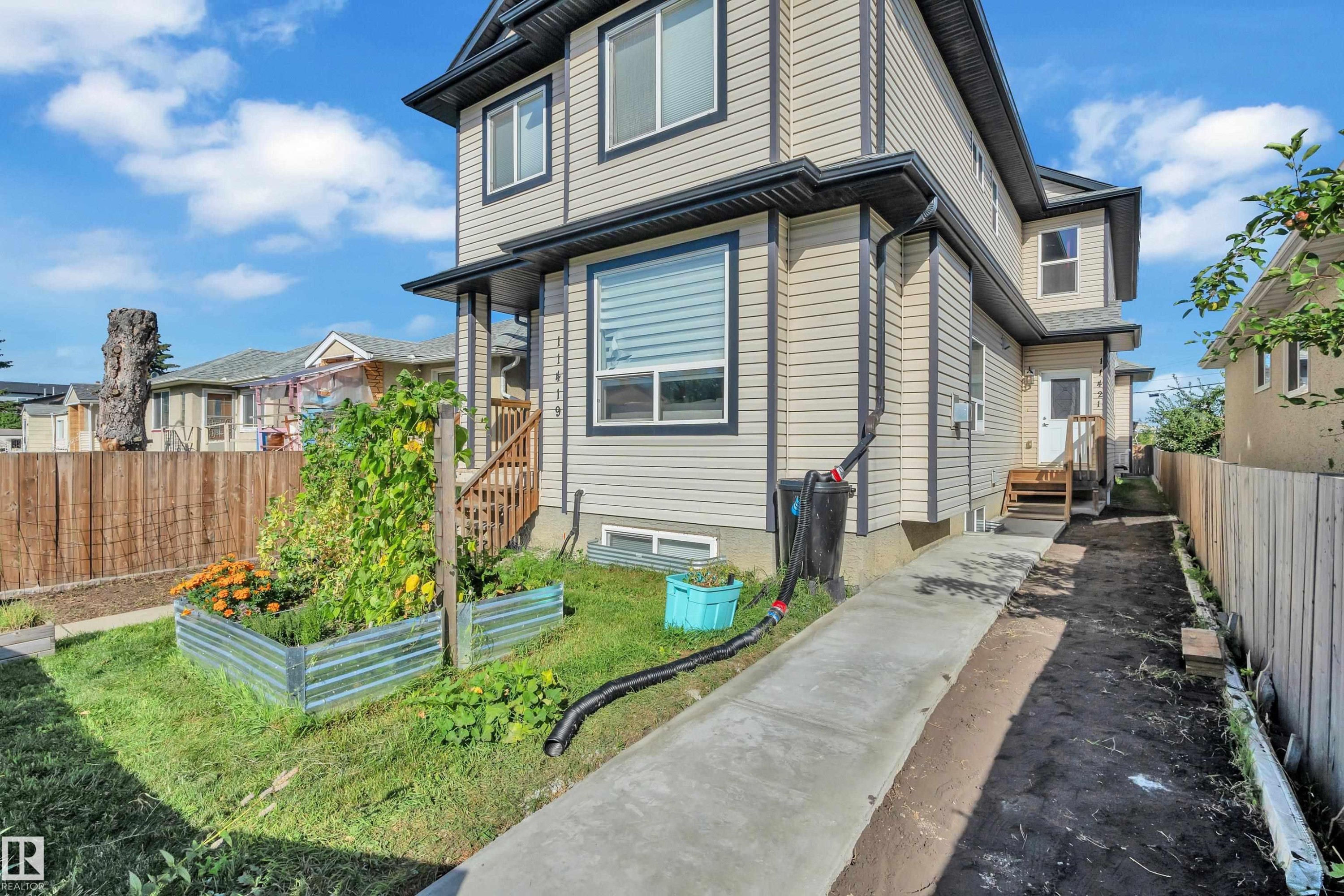 Two-story home with vinyl siding exterior and multi-pane windows - 11421 82 Street Nw, Edmonton, AB