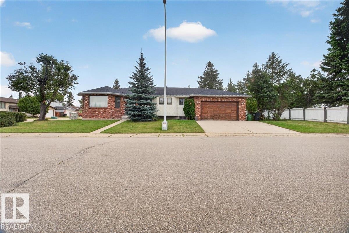 Brick exterior with a dark roof and a prominent front window - 2907 49 Street Nw, Edmonton, AB