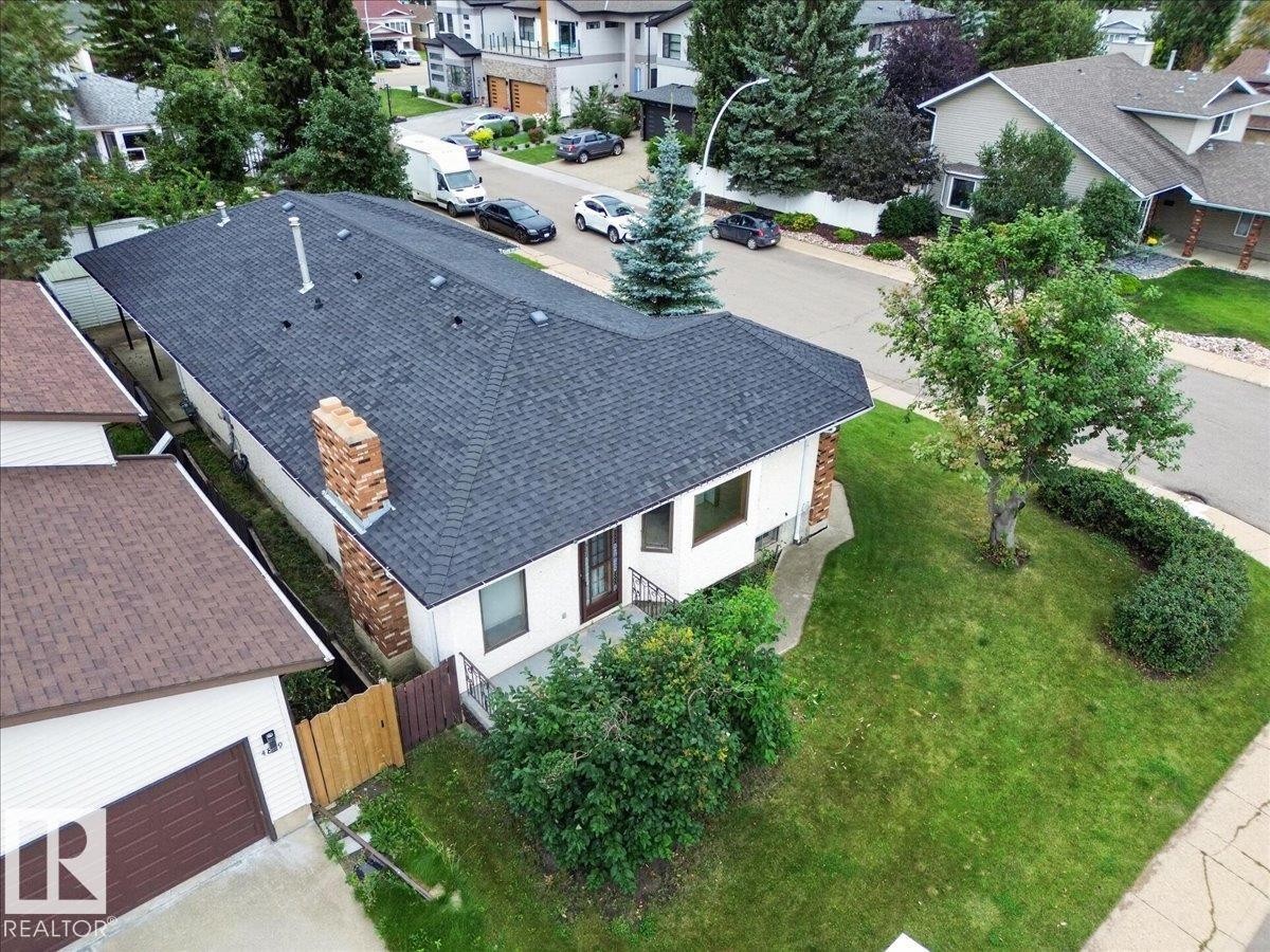 Dark shingle roofing and a brick chimney detail - 2907 49 Street Nw, Edmonton, AB