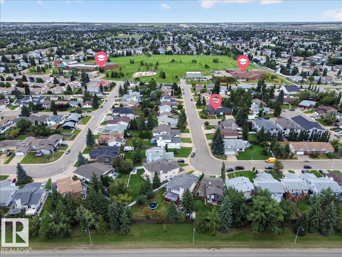 Aerial depiction of a residential neighborhood with numerous detached homes, mature trees, and a large green space - 2907 49 Street Nw, Edmonton, AB
