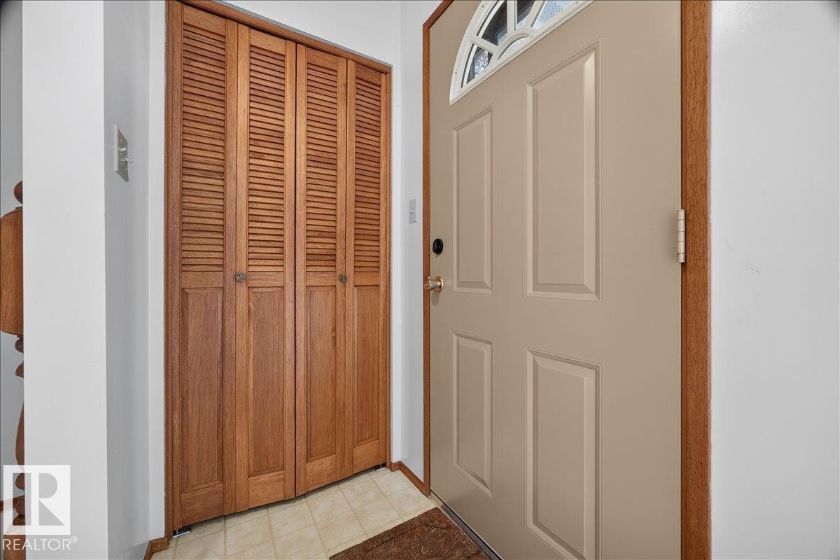 Entry door with an arched decorative glass insert and paneled design - 2907 49 Street Nw, Edmonton, AB
