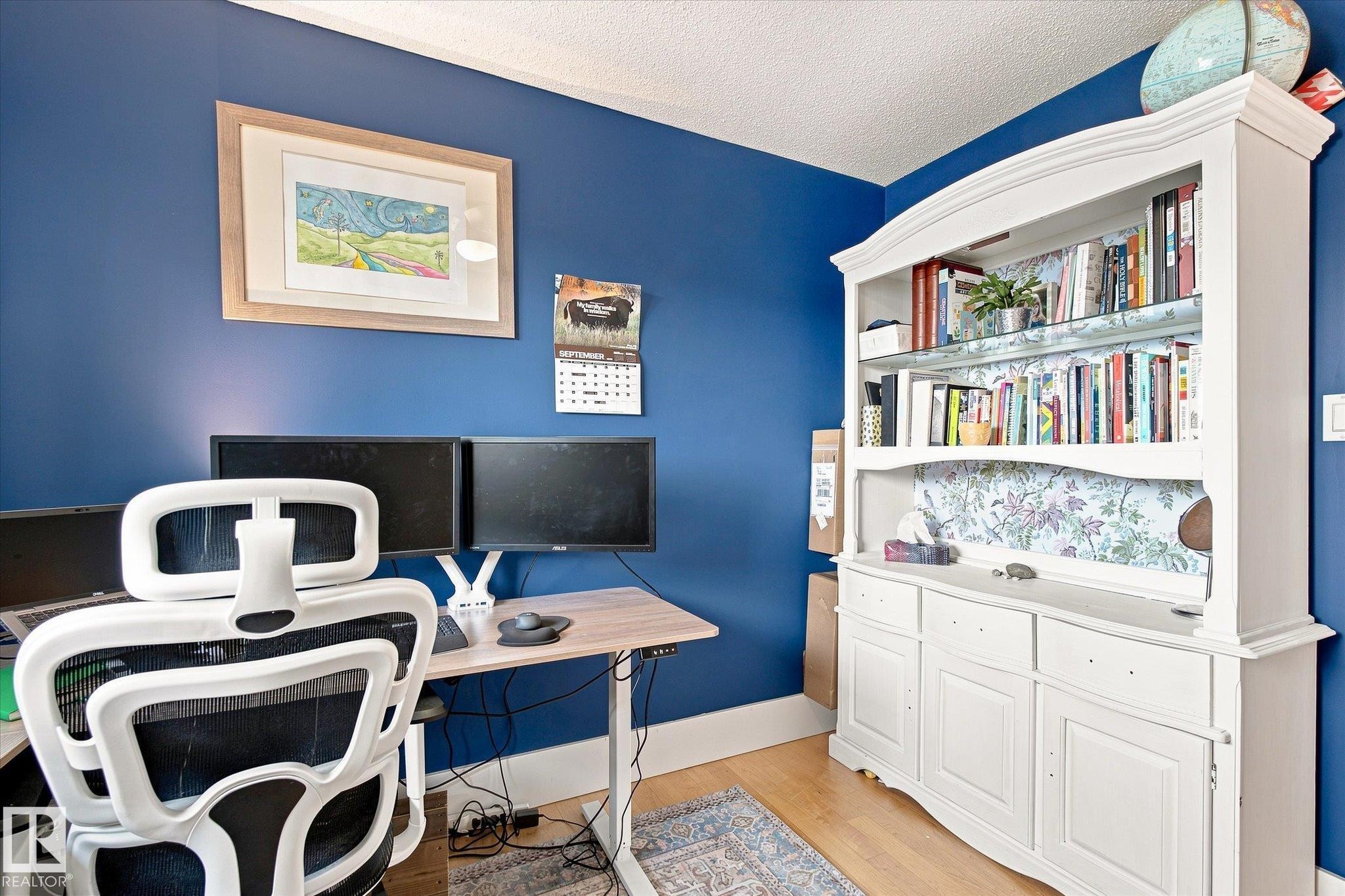 Wood-finish flooring with a white textured ceiling - 3 Akins Drive, St. Albert, AB