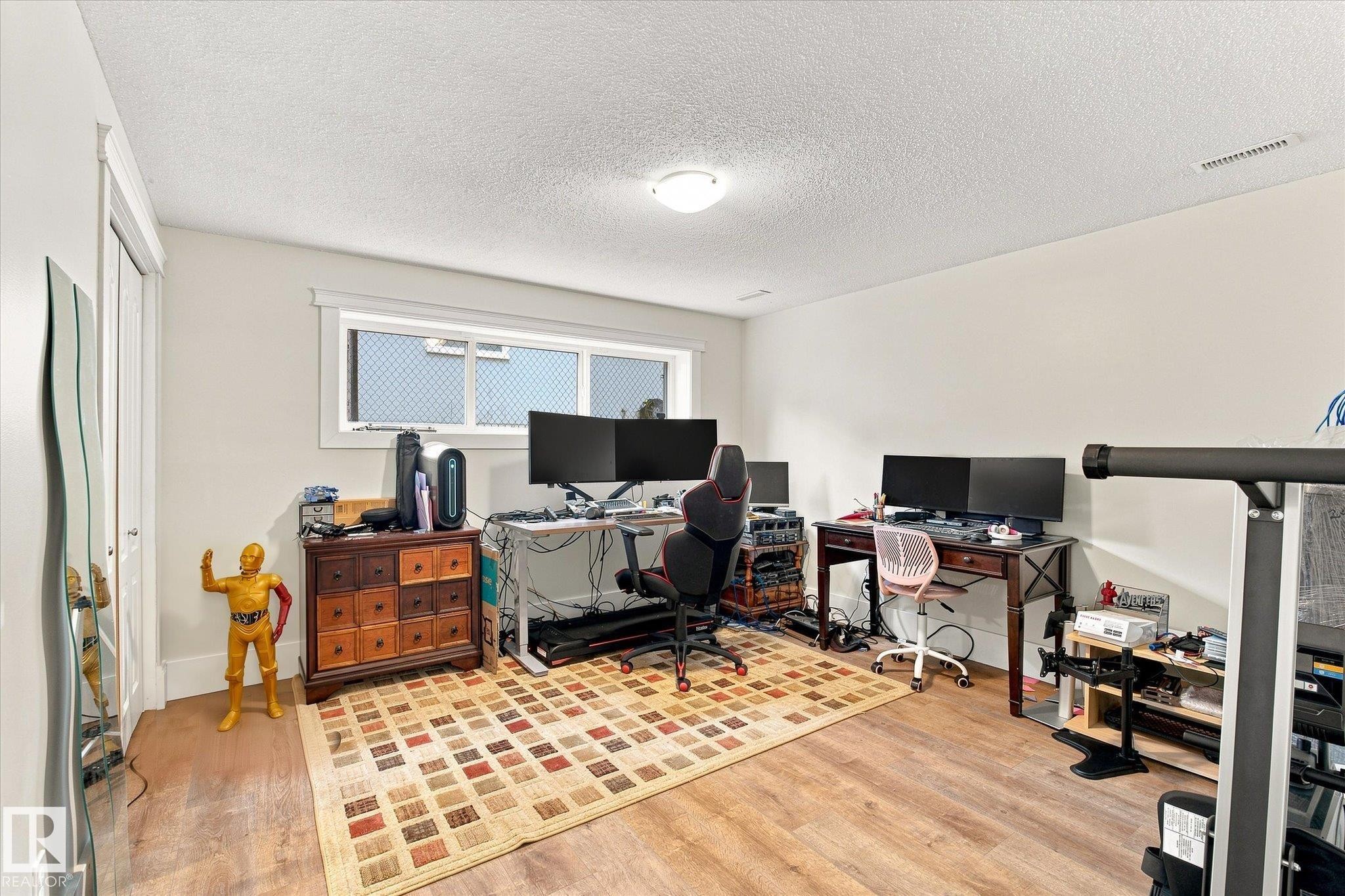 Wood-finish flooring with white walls and a ceiling-mounted light fixture - 3 Akins Drive, St. Albert, AB