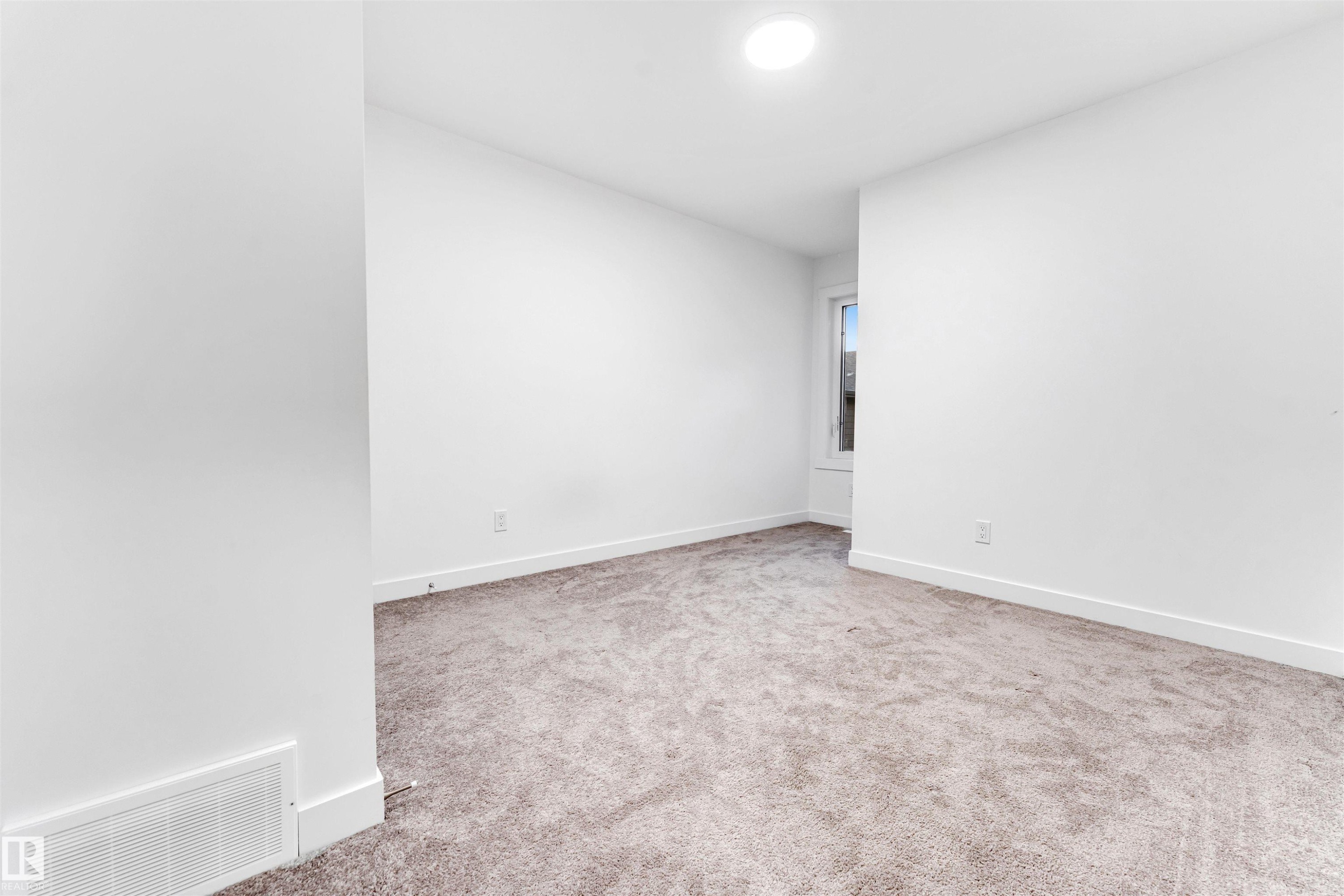Plush carpeting, bright white walls, recessed ceiling lighting, and a single window - #45 2710 66 St Sw, Edmonton, AB
