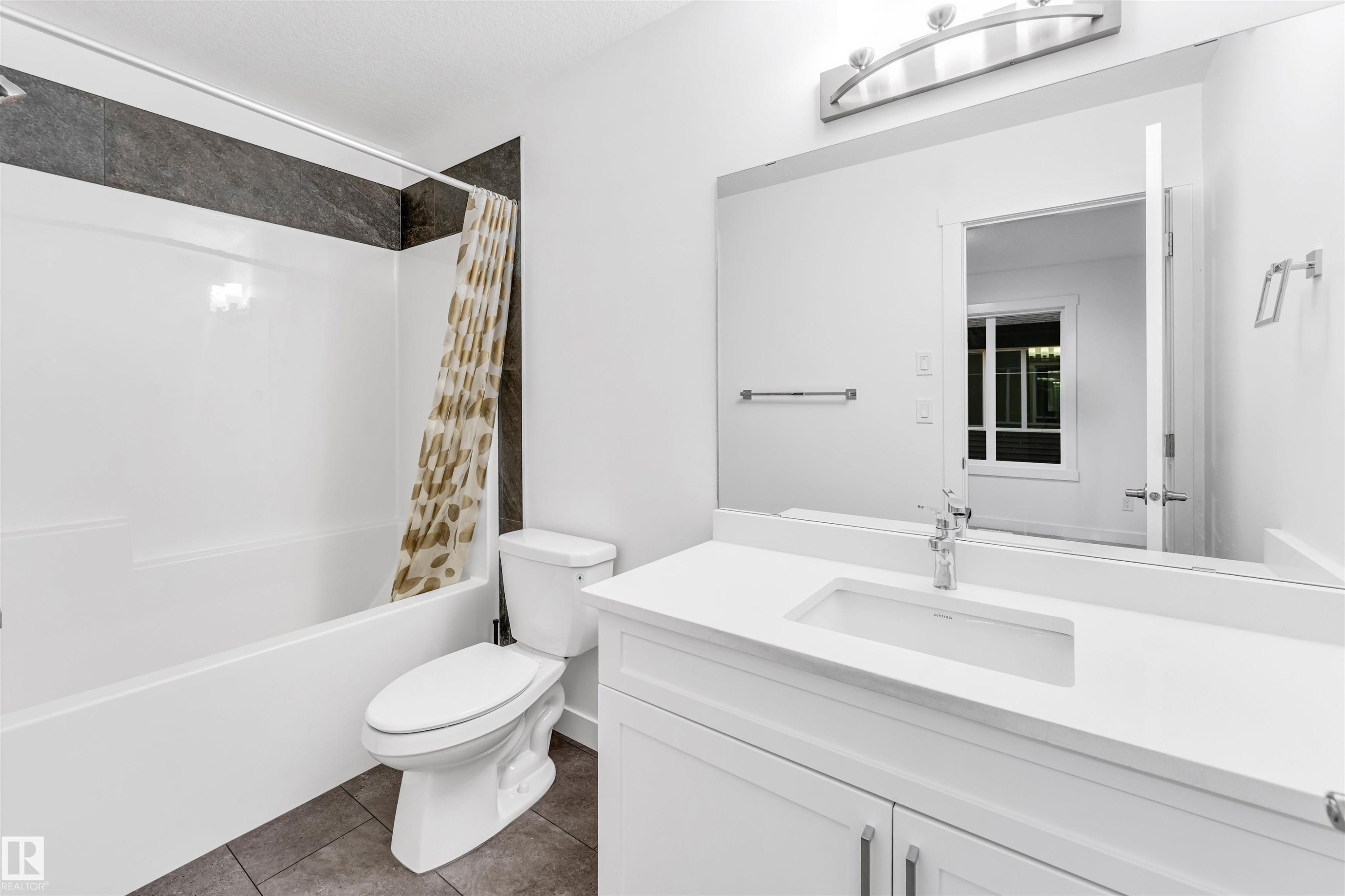 White vanity with an integrated rectangular sink, chrome faucet, and quartz countertop - #45 2710 66 St Sw, Edmonton, AB