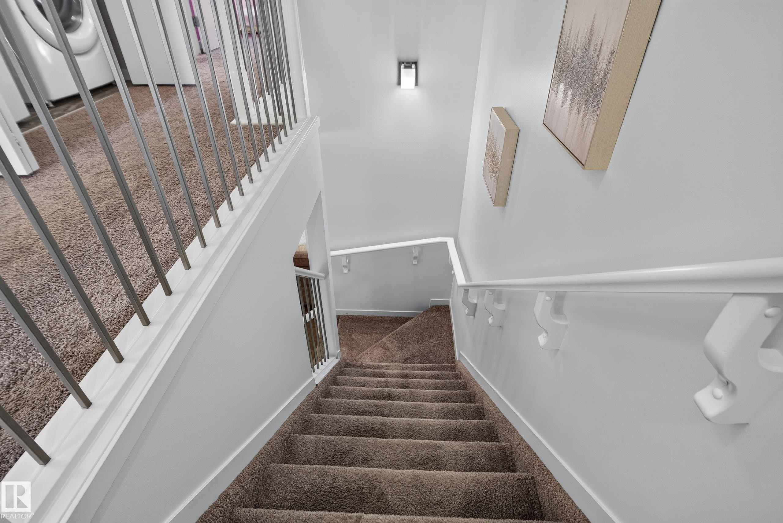 Carpeted staircase with white handrails and modern metal balusters - 17363 120 Street Nw, Edmonton, AB