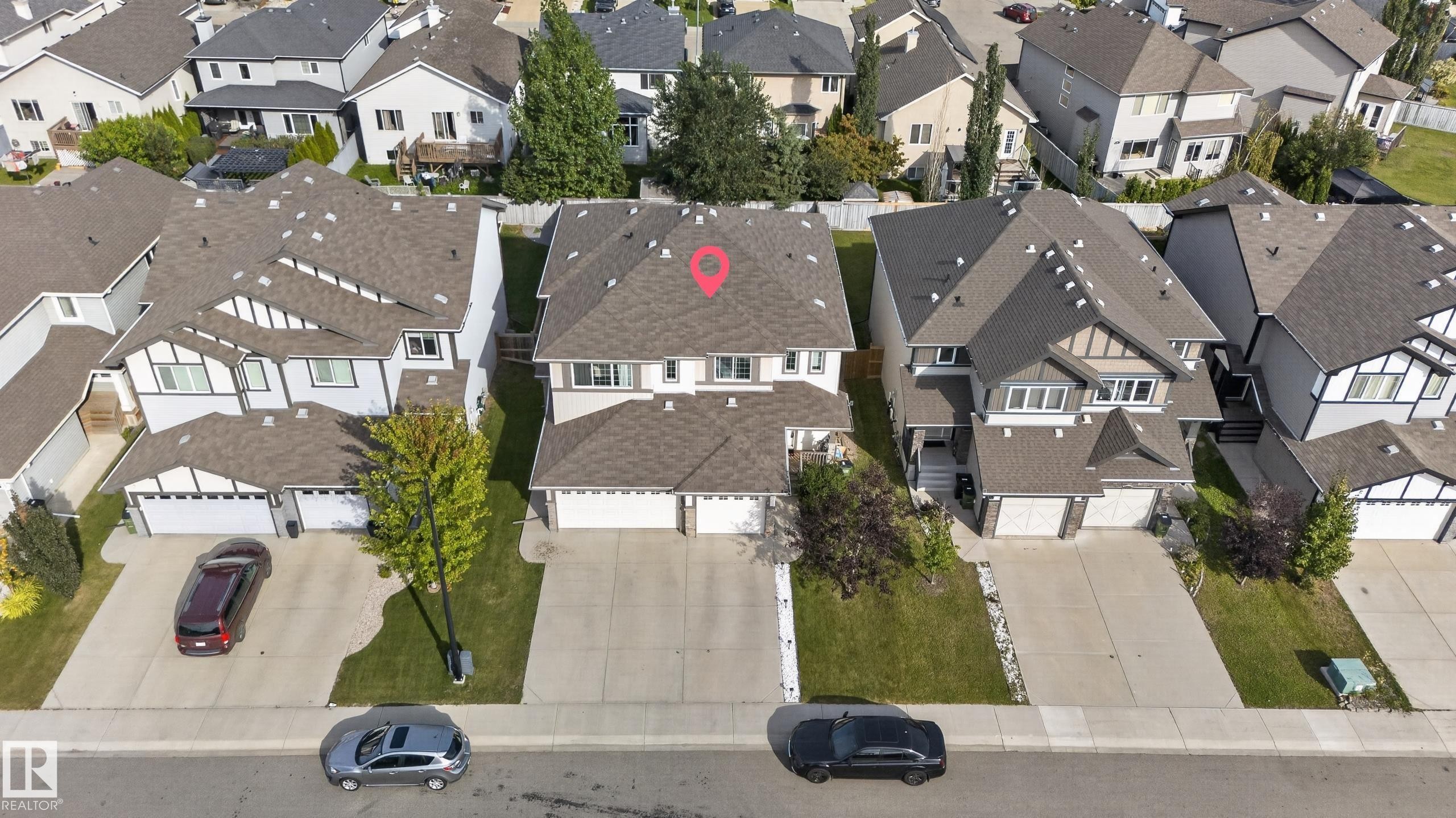 Two-story property with a dual-car garage, concrete driveway, and landscaped front yard - 17363 120 Street Nw, Edmonton, AB