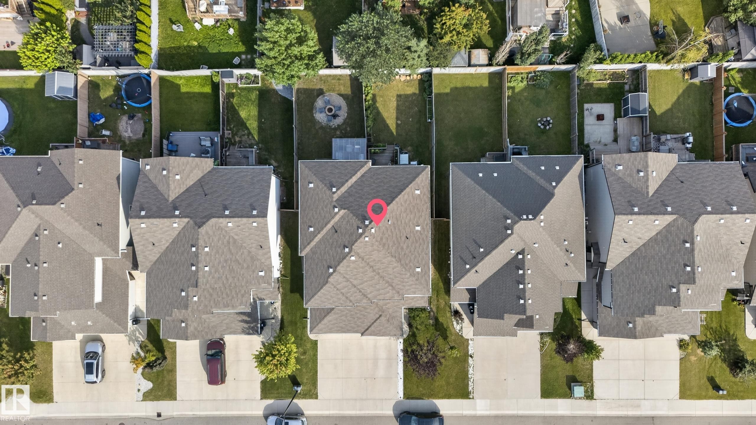 Attached single-family home featuring a pitched roofline, paved driveway, and a private backyard with a green lawn - 17363 120 Street Nw, Edmonton, AB