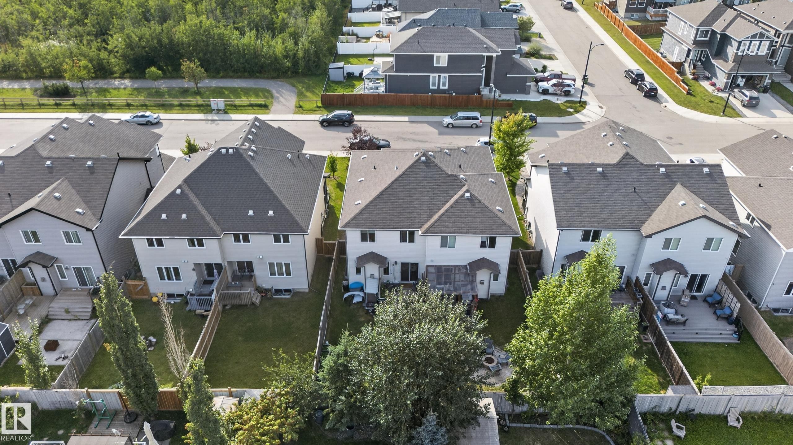Two-story residence with a gabled roof, light-toned siding, and multiple rear windows - 17363 120 Street Nw, Edmonton, AB