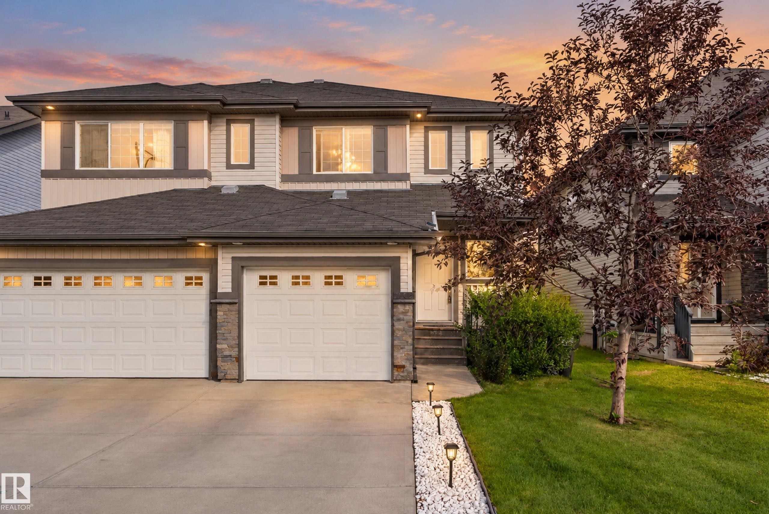 Two-story exterior with light-toned siding and dark trim accents - 17363 120 Street Nw, Edmonton, AB