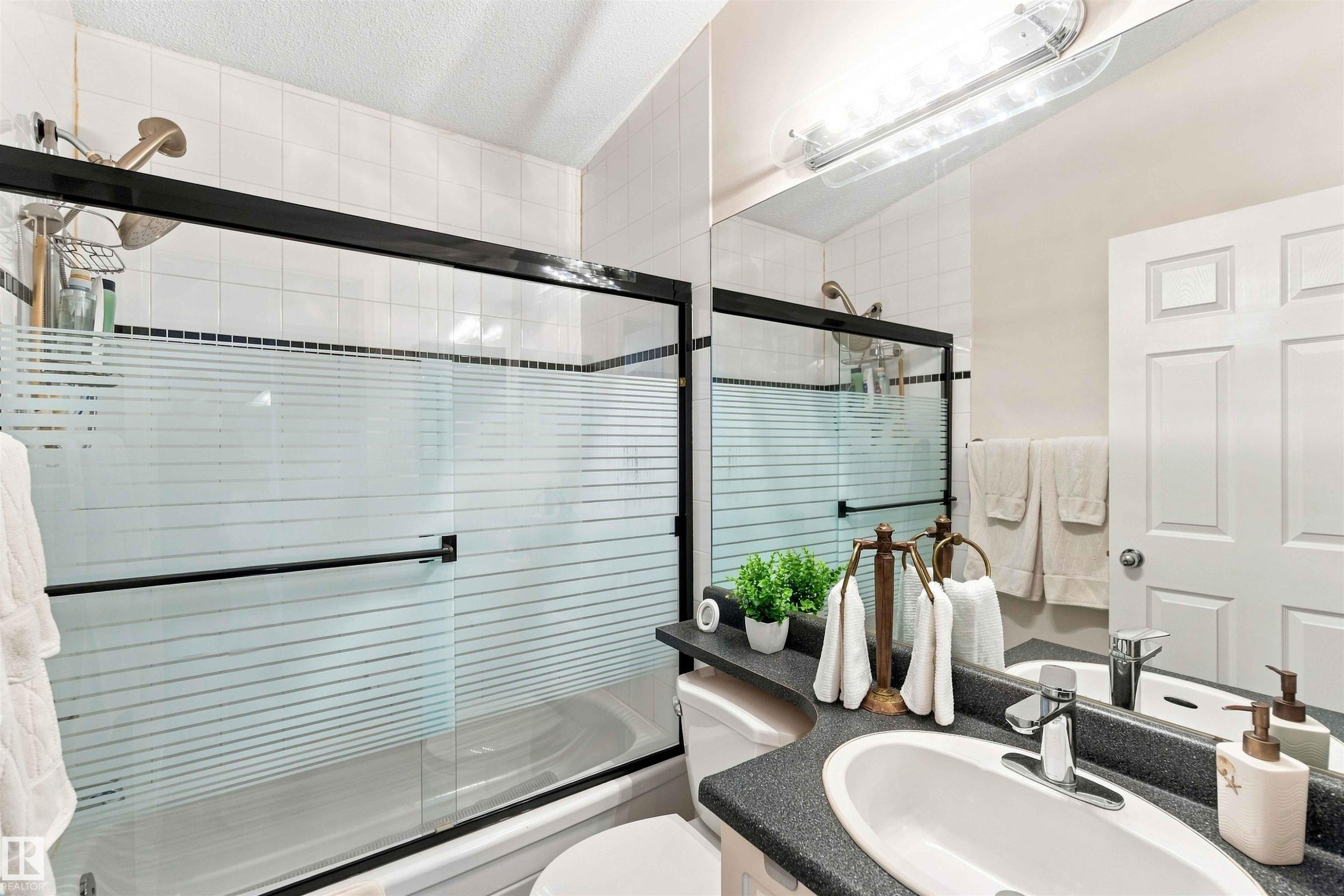 Vanity with an oval undermount sink and chrome faucet - #6 15 Poirier Av, St. Albert, AB