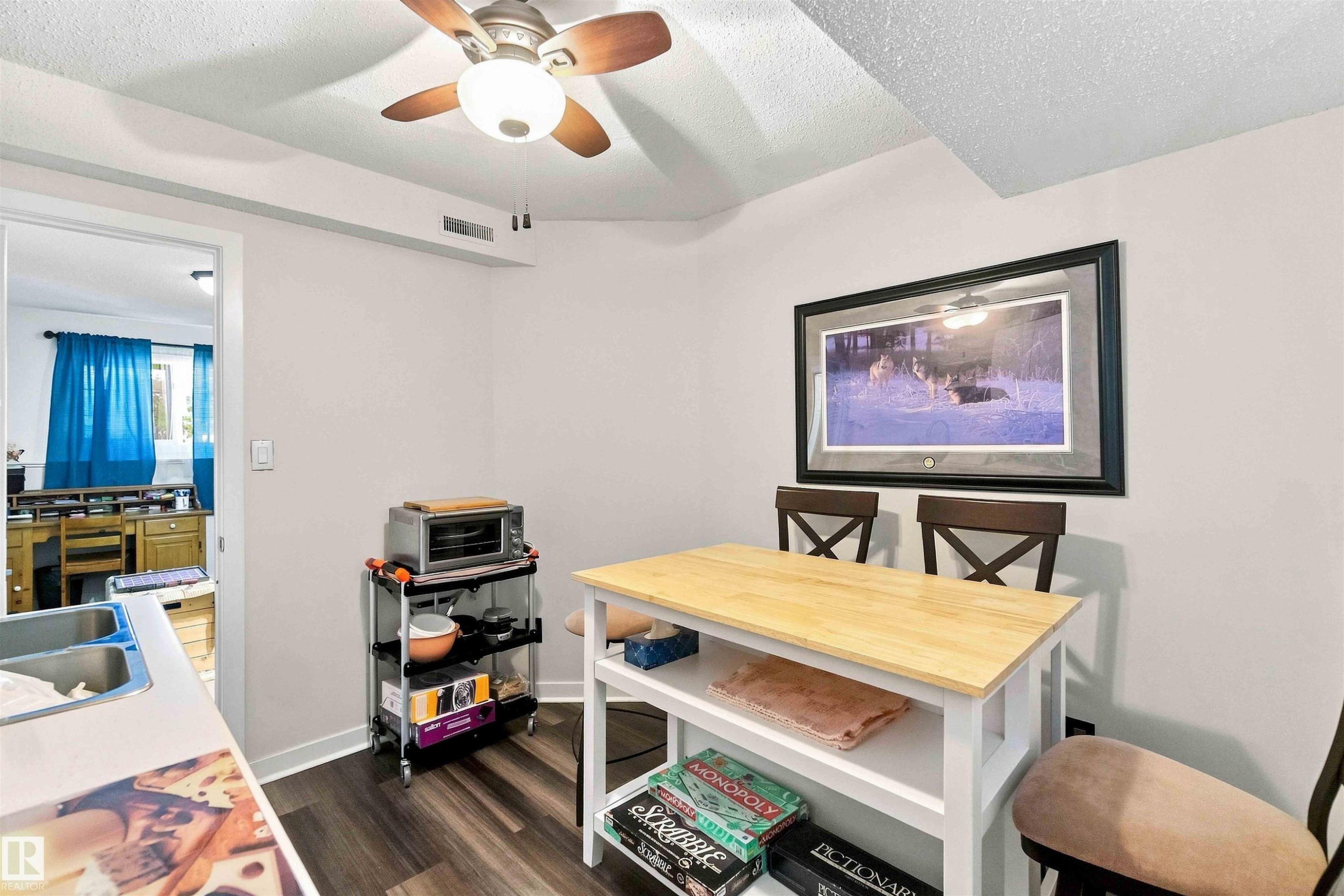 Wood-finish flooring with light-toned walls - #6 15 Poirier Av, St. Albert, AB