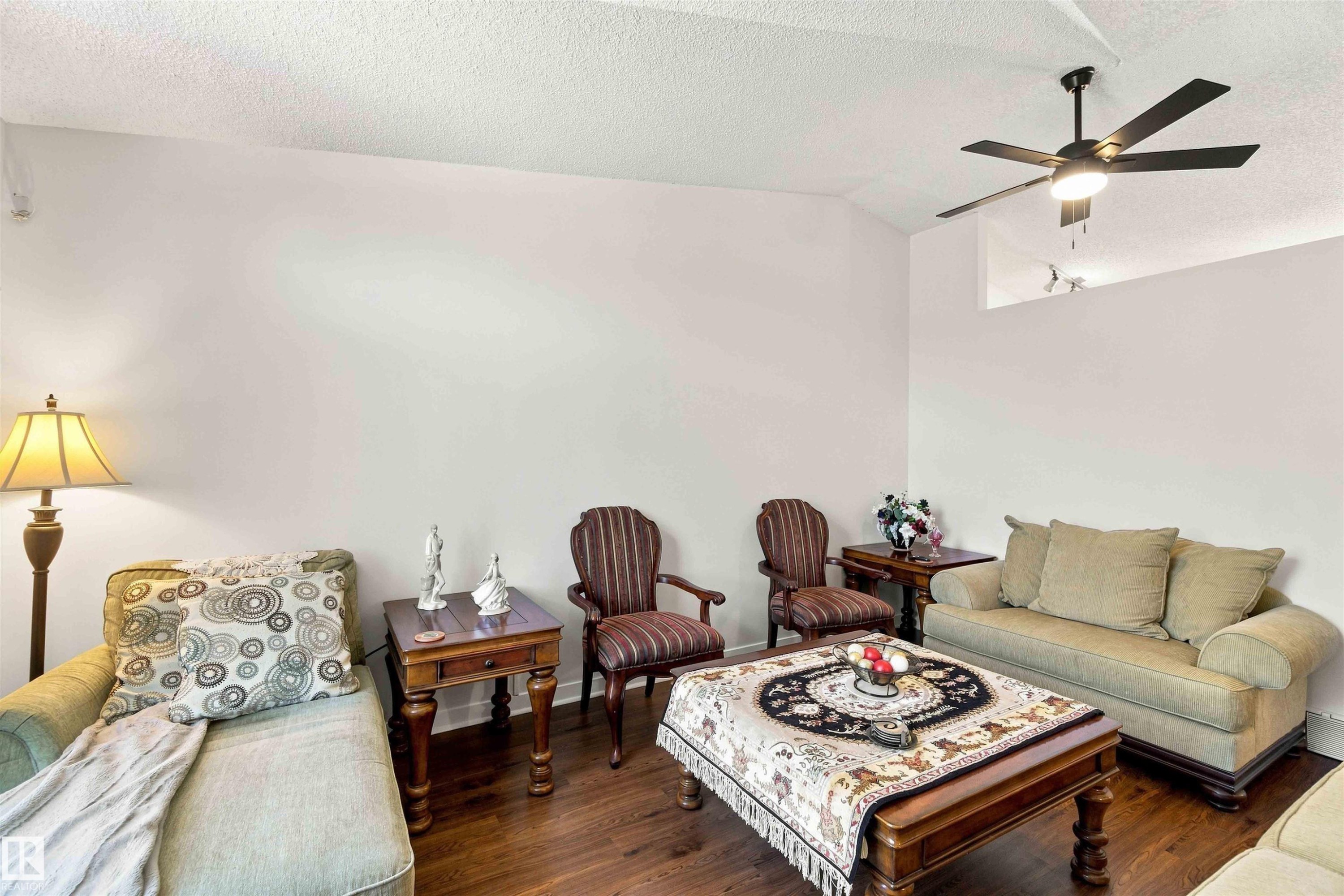 Vaulted ceilings with a ceiling fan, wood-finish flooring, and a decorative niche - #6 15 Poirier Av, St. Albert, AB