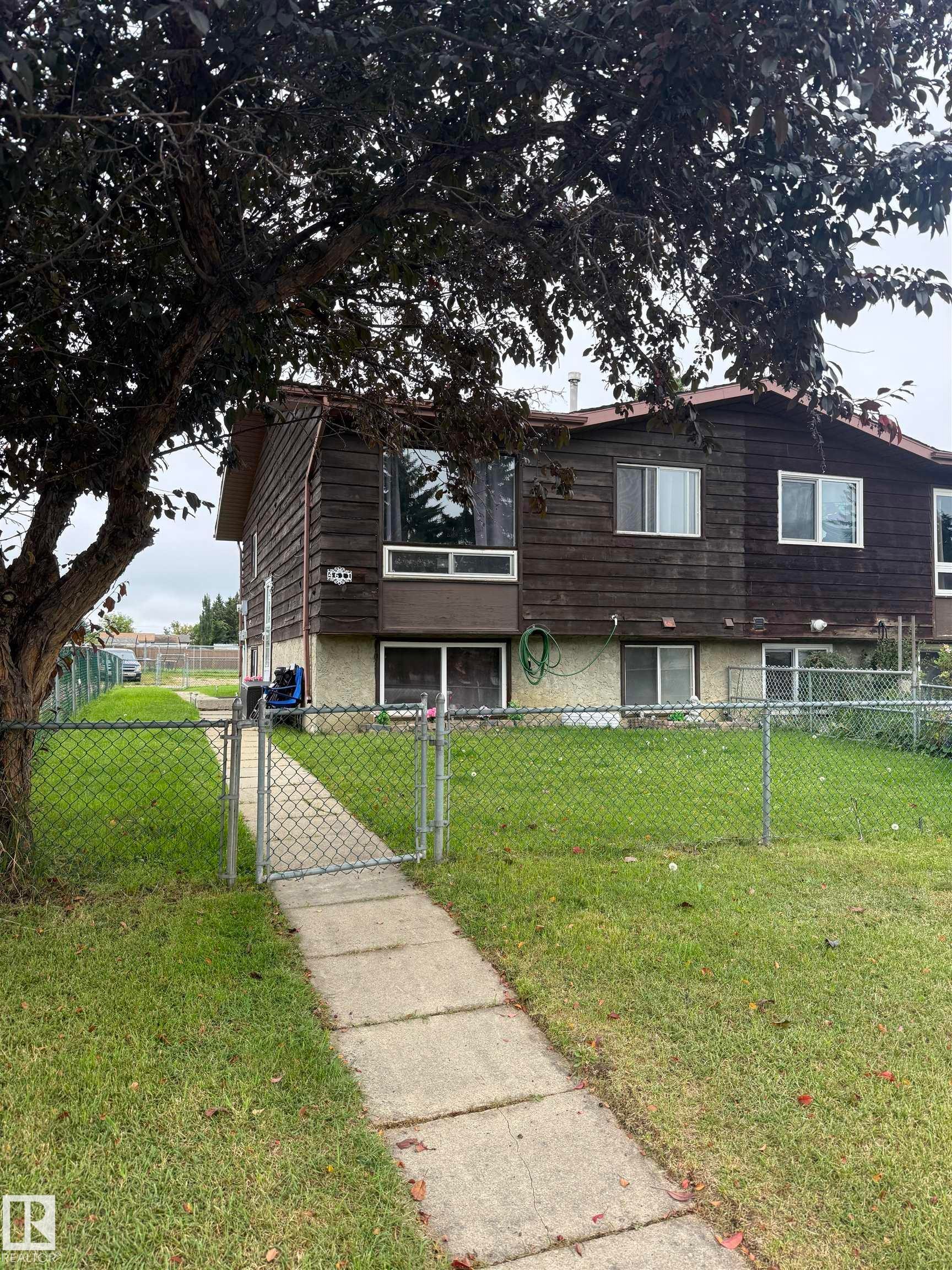 Wood-clad exterior with multiple windows - 4611 52 Avenue, Stony Plain, AB