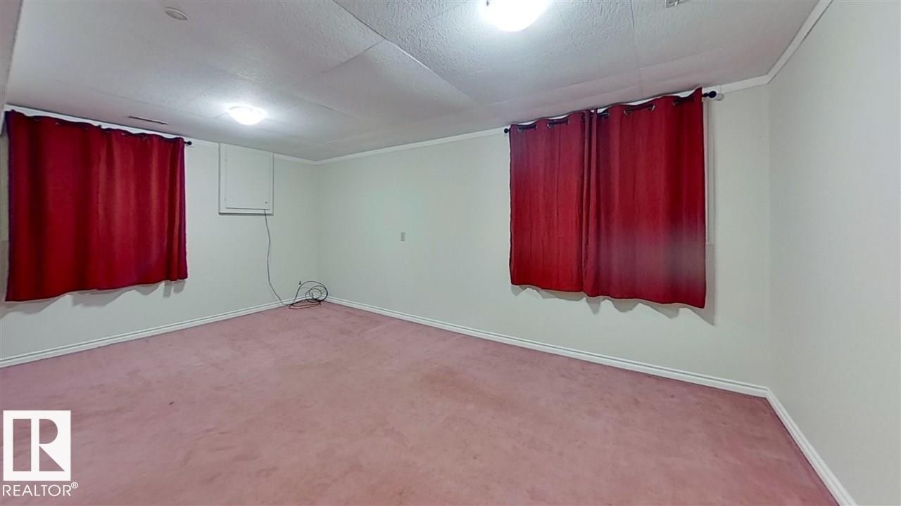 Carpeted flooring, white walls, and ceiling-mounted lighting fixtures - 4611 52 Avenue, Stony Plain, AB