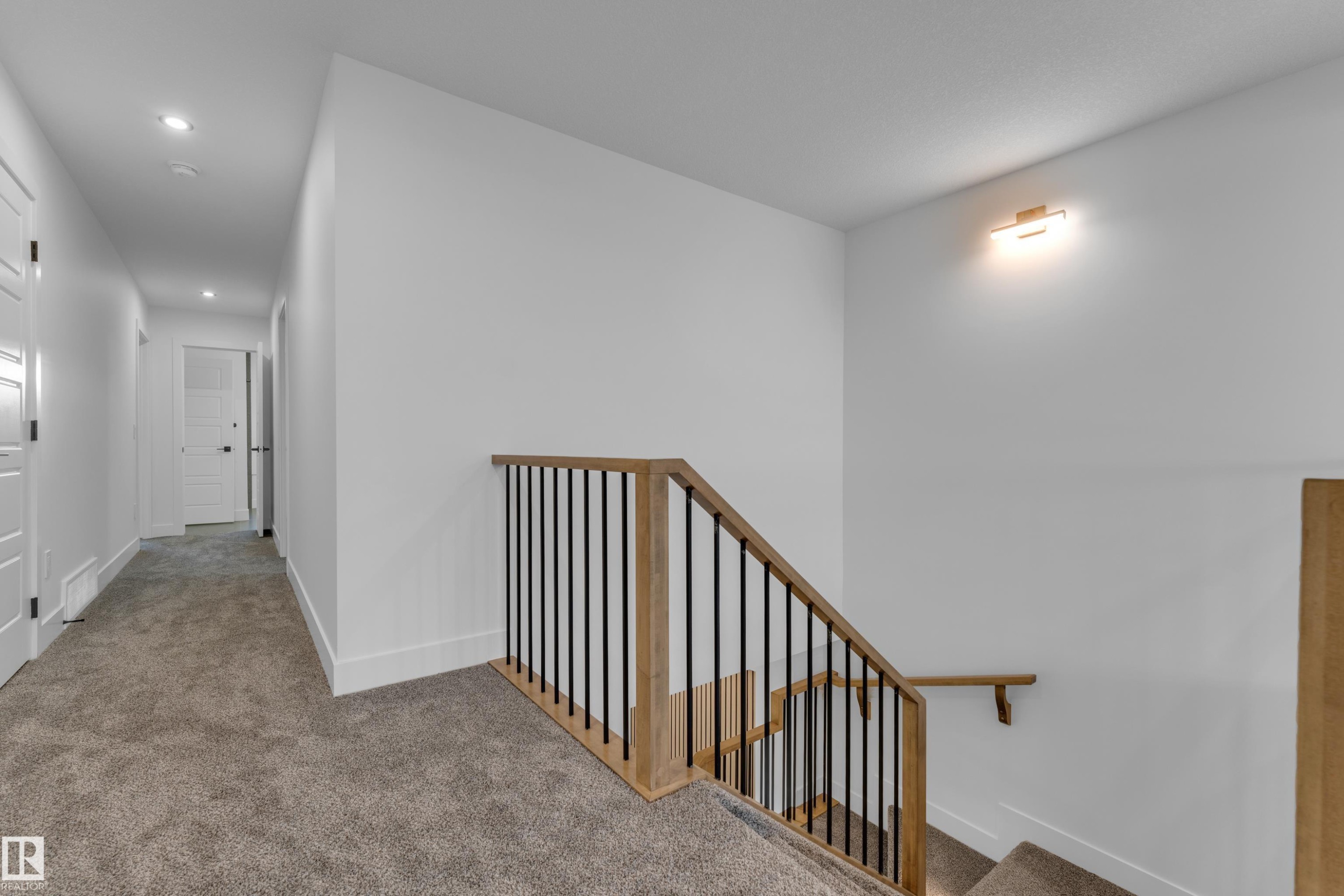 Carpeted hallway with recessed lighting and paneled doors - 236 Linden Loop, Leduc, AB