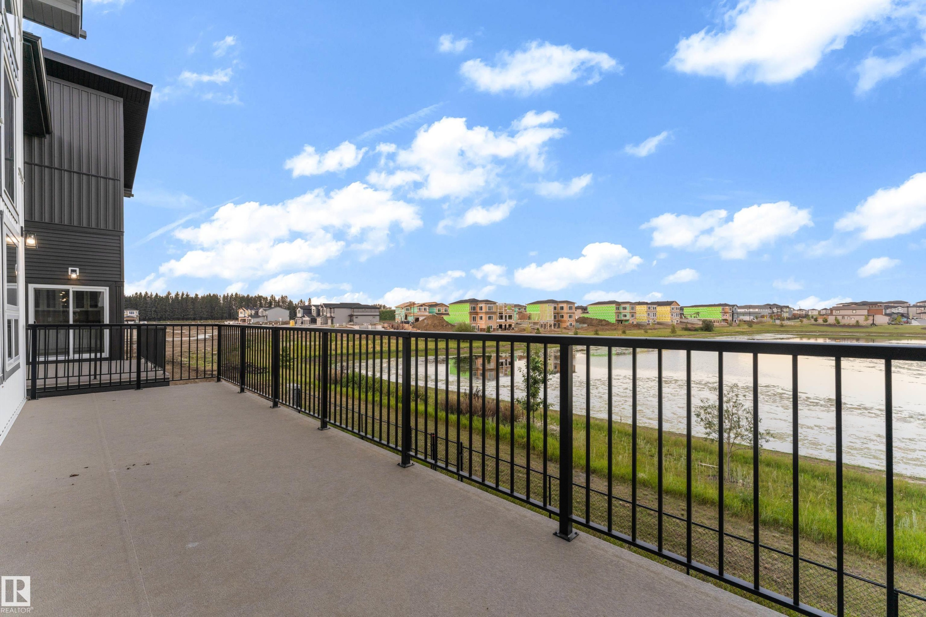 Expansive concrete balcony with black metal railings - 236 Linden Loop, Leduc, AB