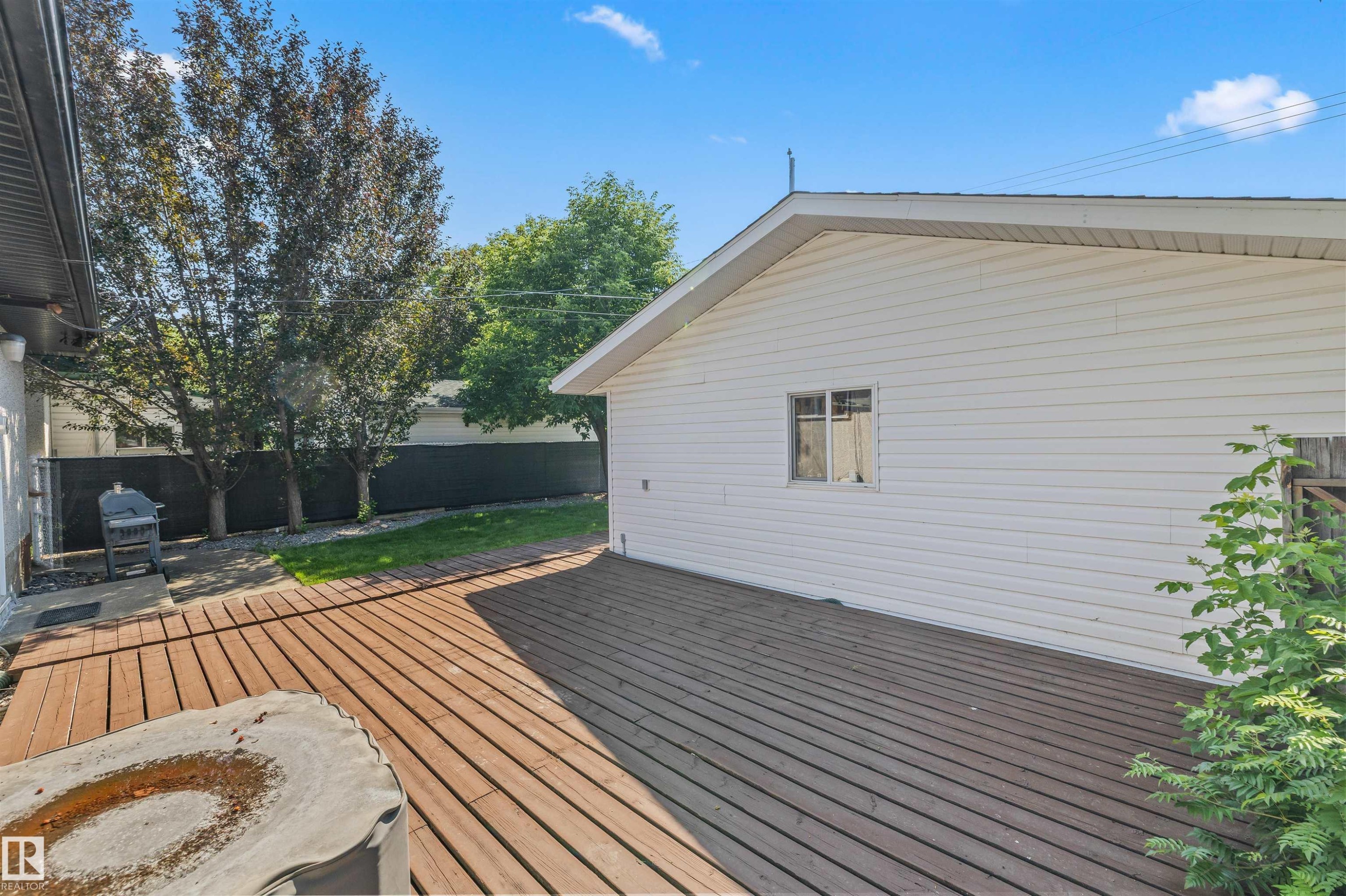 Expansive outdoor decking features a wood-finish surface - 13320 123 Street Nw, Edmonton, AB - Outdoor With Exterior