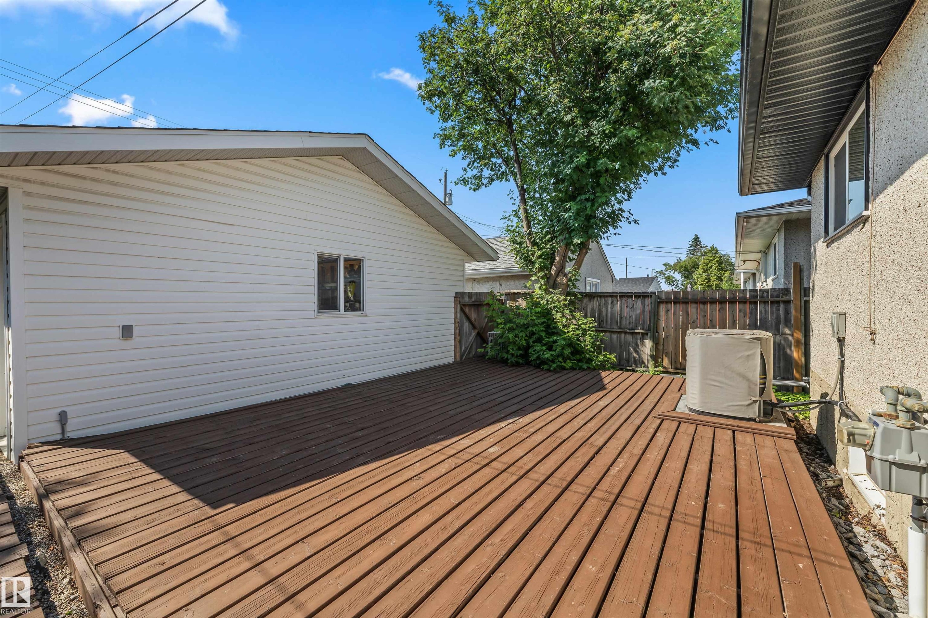 Expansive wood-finish deck with a privacy fence - 13320 123 Street Nw, Edmonton, AB - Outdoor With Deck Patio Veranda With Exterior