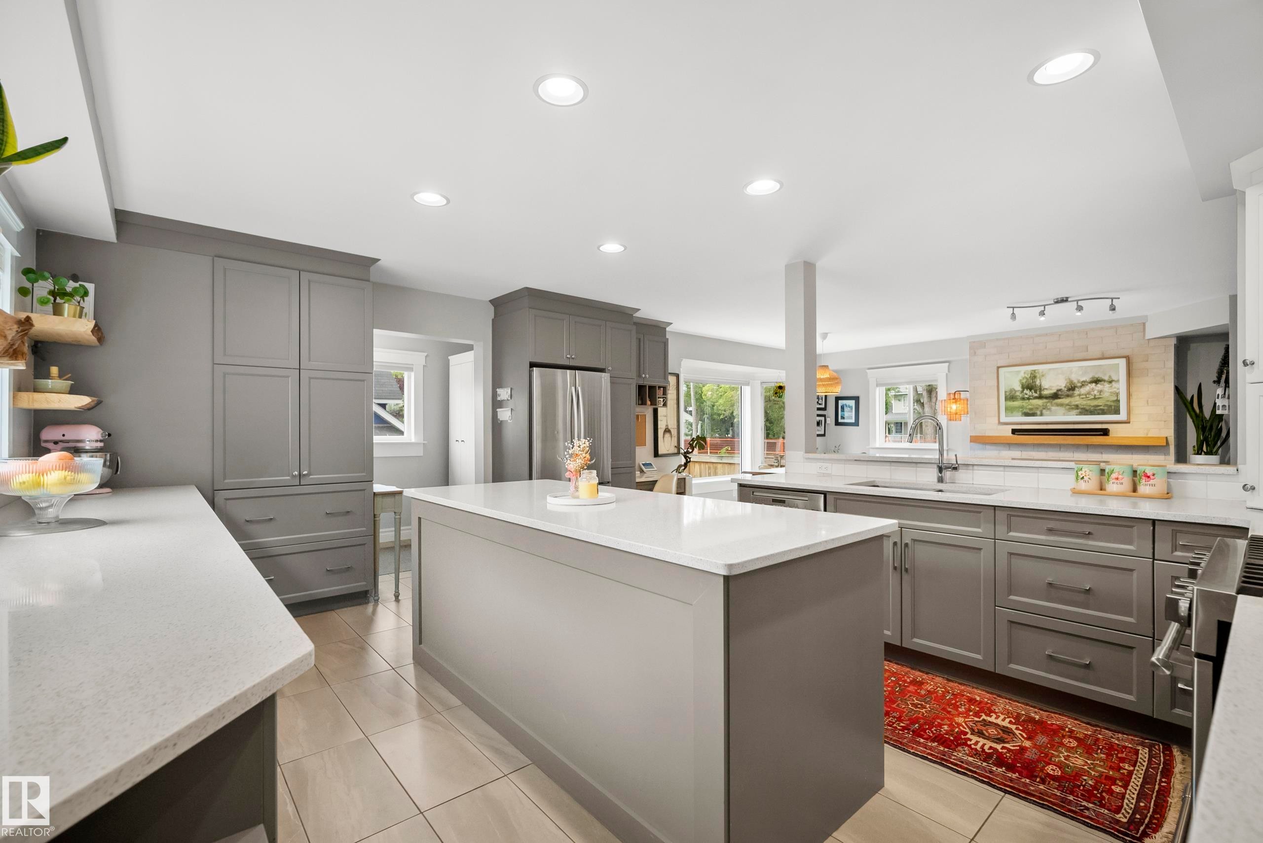 Contemporary kitchen with gray cabinetry, white countertops, a center island, recessed lighting, and tile flooring - 11006 64 Avenue Nw, Edmonton, AB