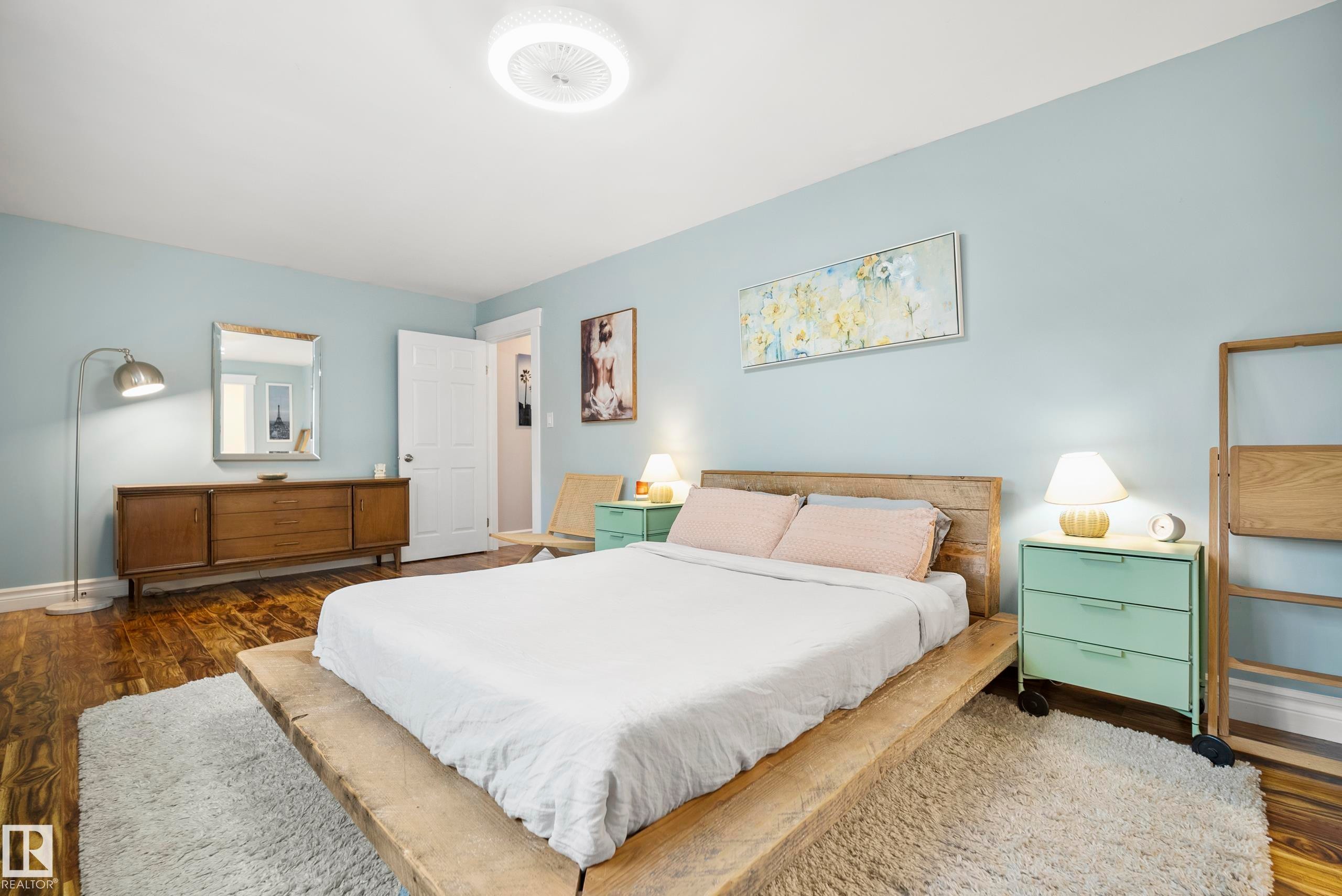 Hardwood-finish flooring, light-toned walls, and a contemporary ceiling light fixture - 11006 64 Avenue Nw, Edmonton, AB