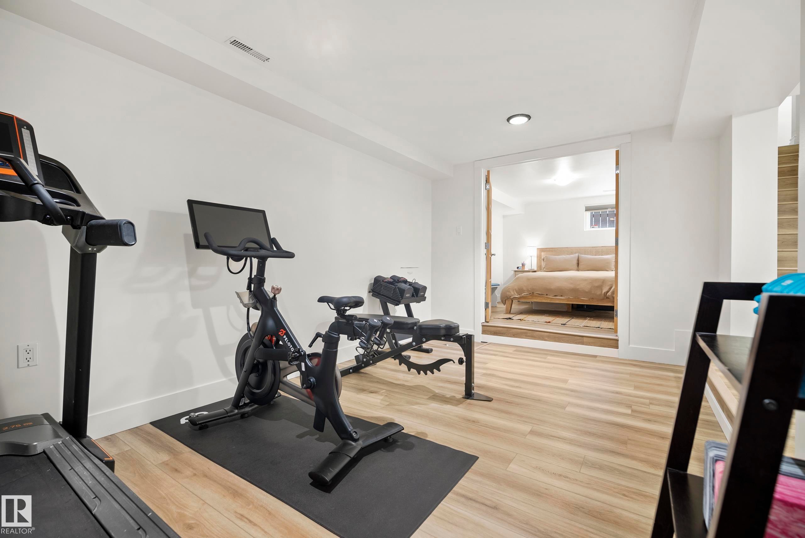 Open concept interior with light wood-finish flooring, recessed lighting, and a wide entryway - 11006 64 Avenue Nw, Edmonton, AB